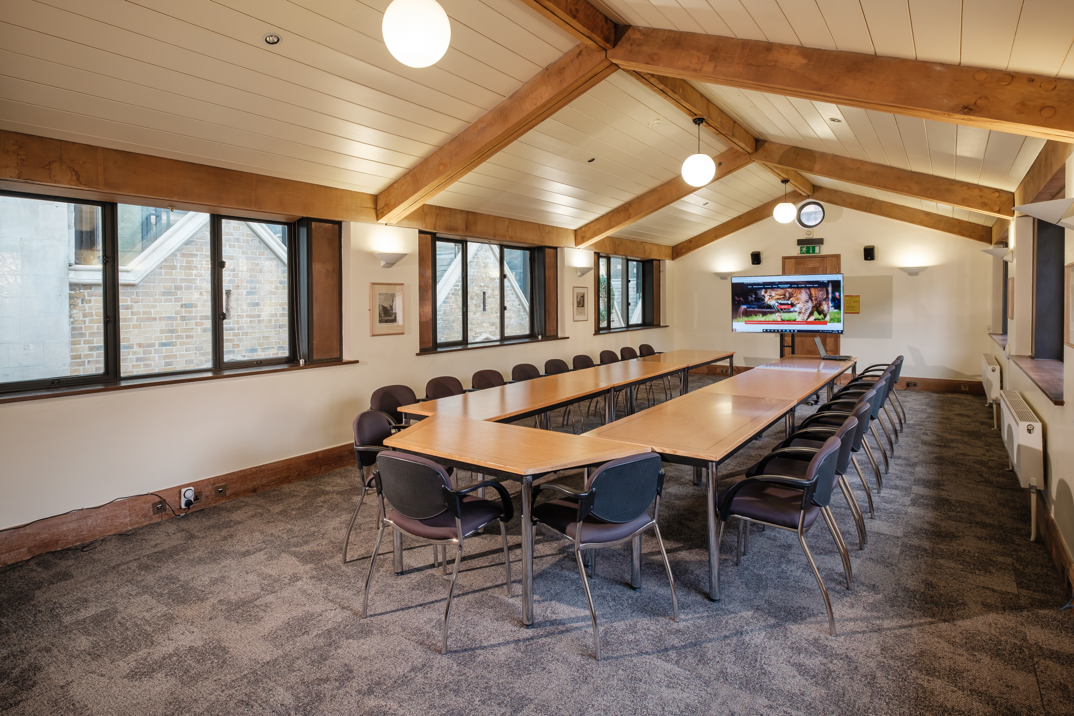 Boardroom-style layout with large tables and stacking chairs, ideal for team away days or meetings near London Bridge