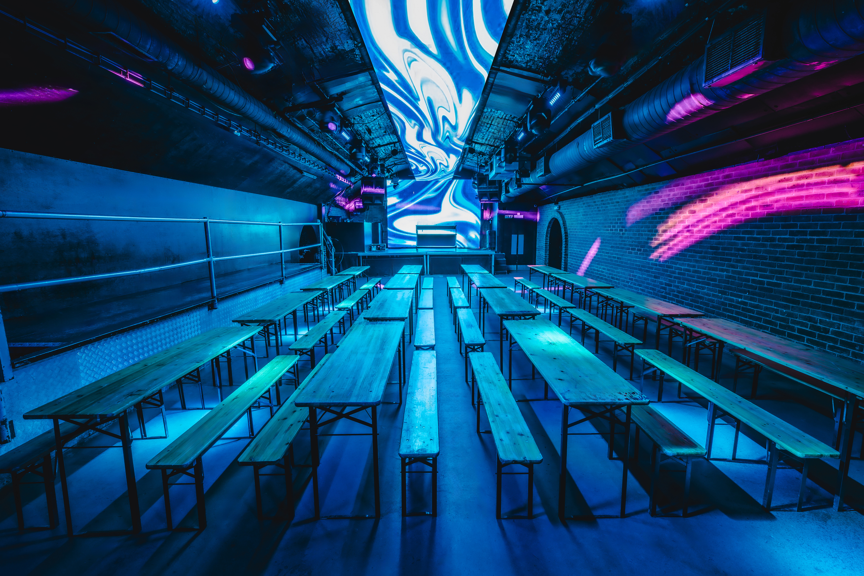 A view from the stage of the 600-capacity Fire Main Room, set theatre-style with advanced digital ceiling panels, bookable through Conveenie.