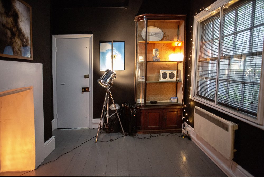 Quirky The Den at Anomalous Space, a small meeting room for 3 people, featuring fairy lights and a vintage glass display cabinet - book via Conveenie.