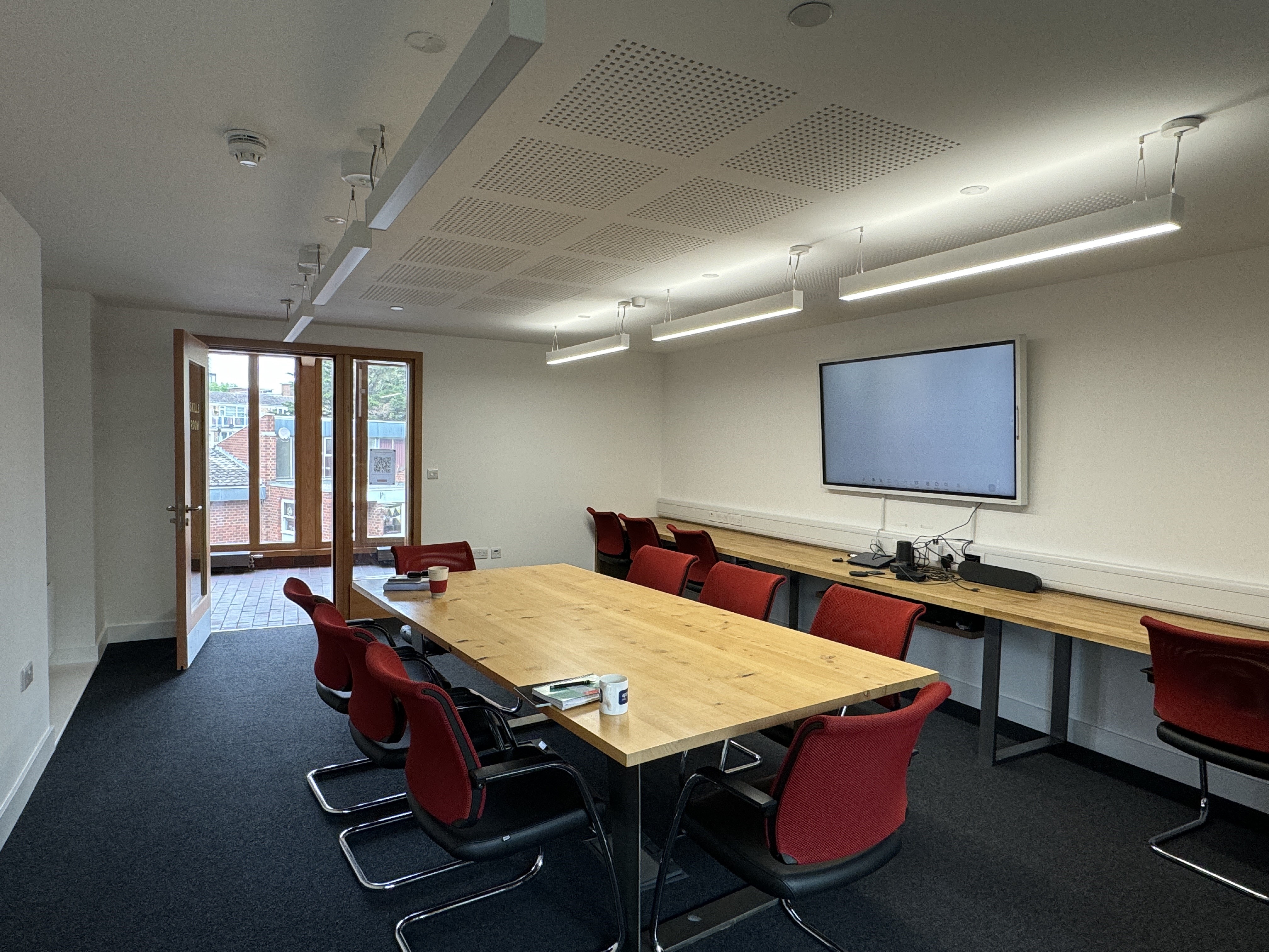 Modern meeting room hire in London at Appleby Blue, a training space for 16 people, with a large TV and balcony access.