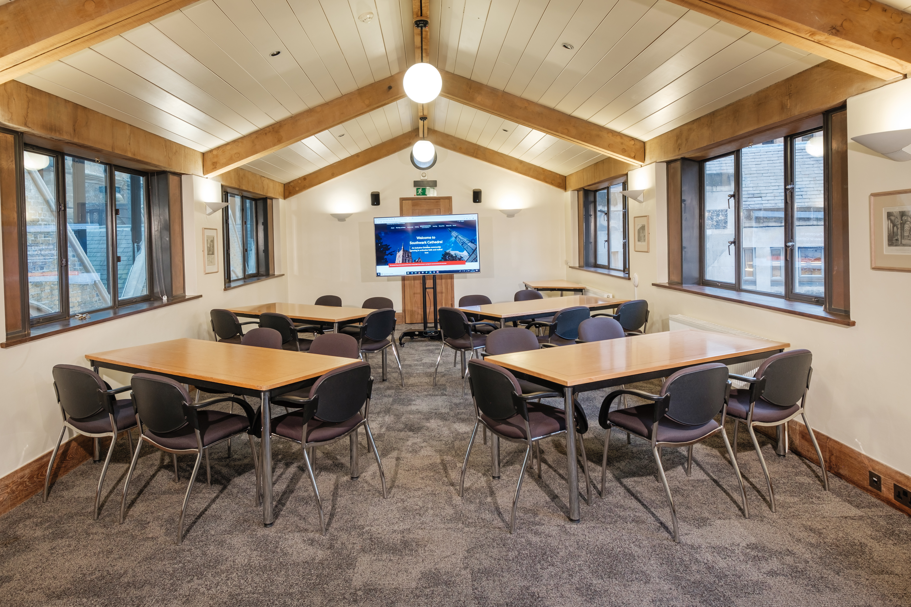 Seating setup in the John Trevor Williams Room with 30 chairs and natural light overlooking the River Thames