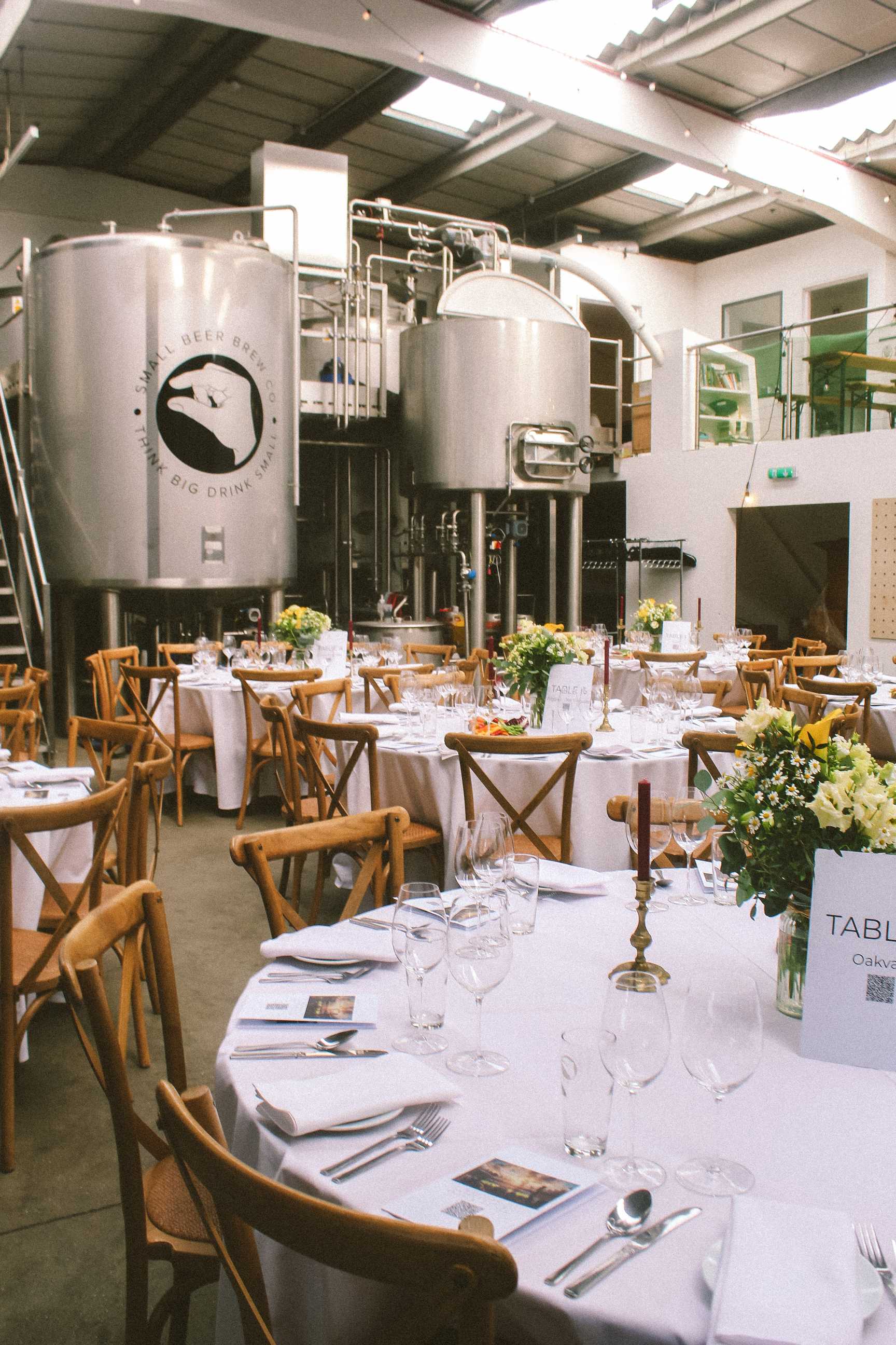 Small Beer Brew Taproom industrial London wedding venue with exposed beams, polished concrete, and brewery backdrop