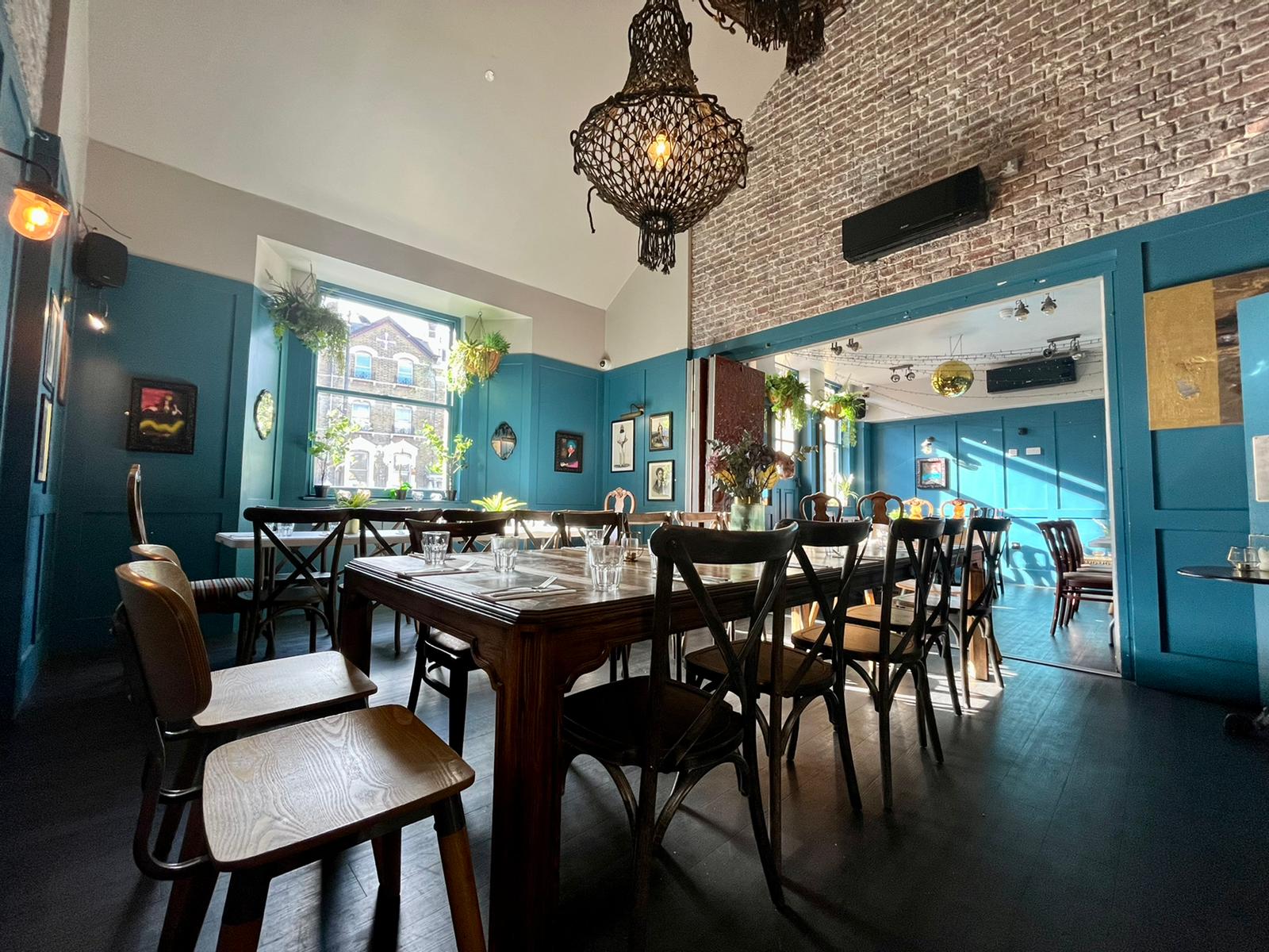 Versatile indoor function space at The Greyhound with screen setup, listed on Conveenie for meetings and social gatherings