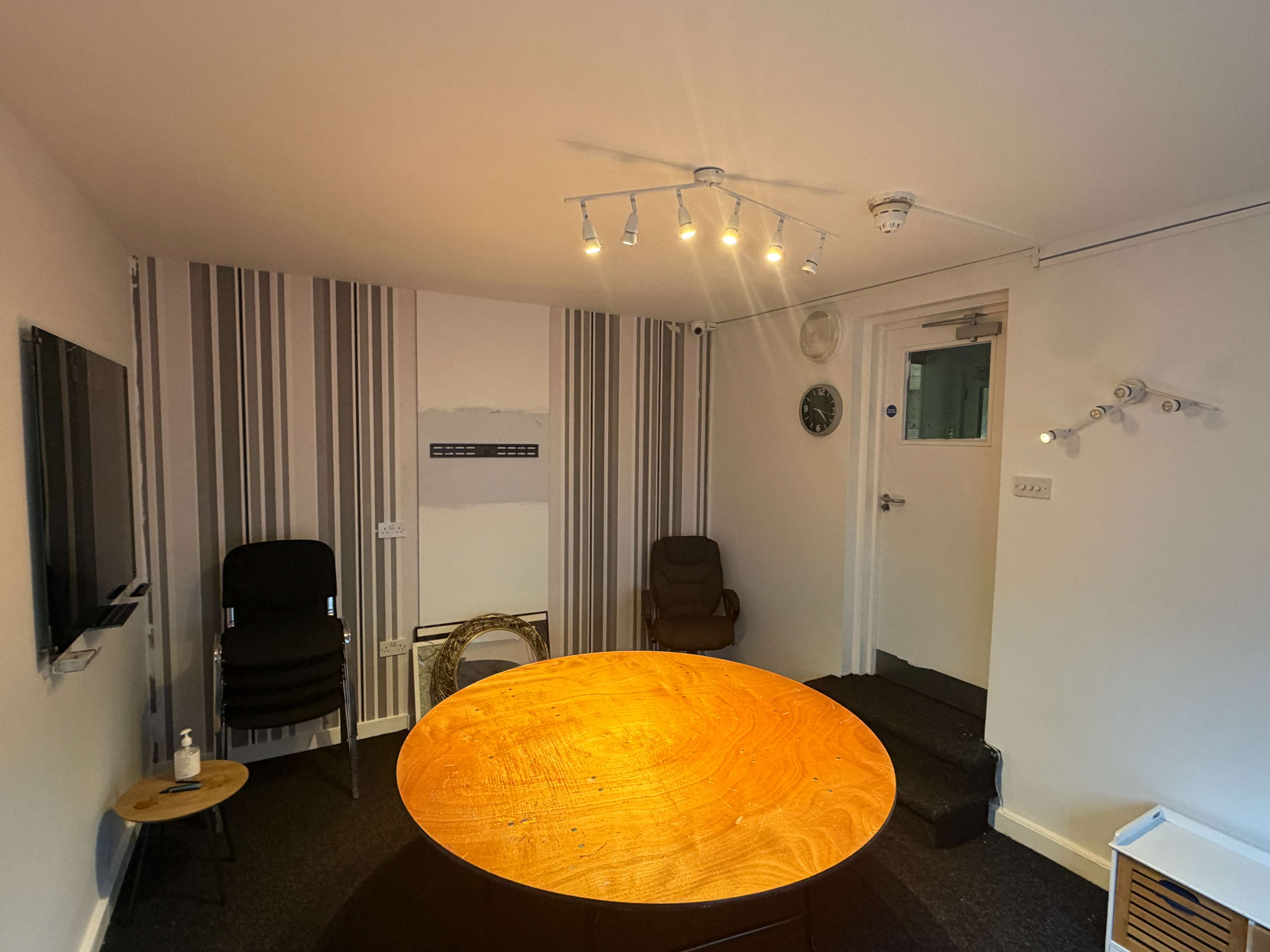 Meeting room with table, blackboard and chairs at Bradfield Club Peckham