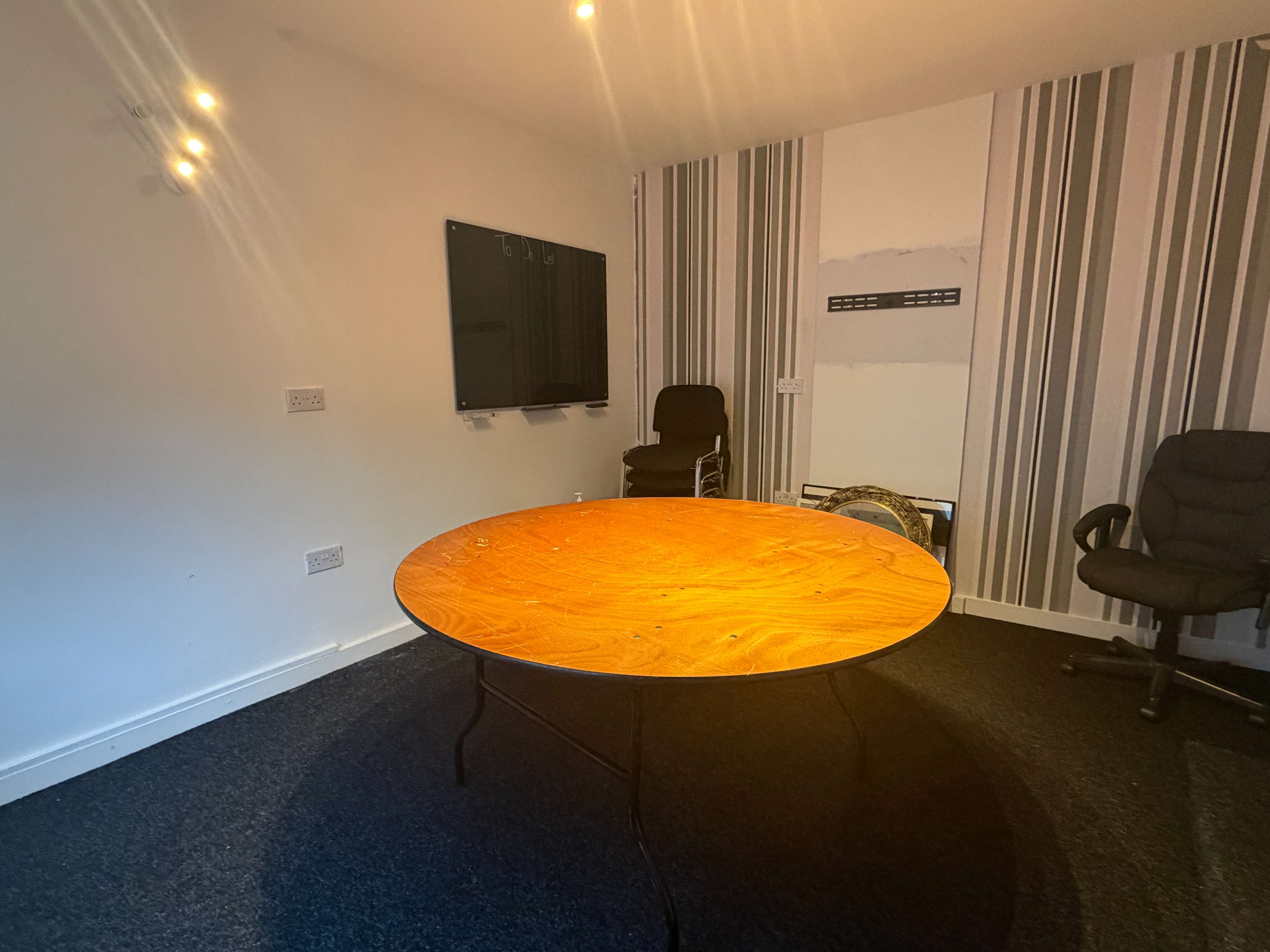 Meeting room with table, blackboard and chairs at Bradfield Club Peckham