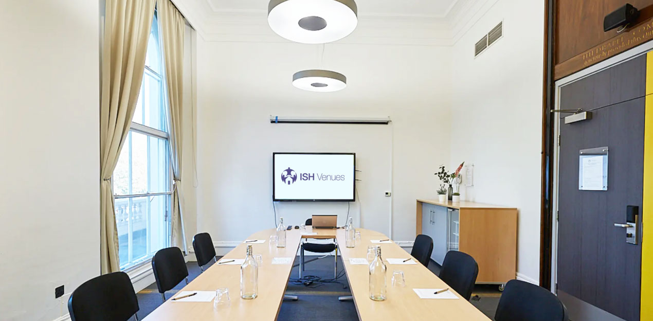 Regency style corporate boardroom in Central London featuring integrated flat screen video conferencing tech.