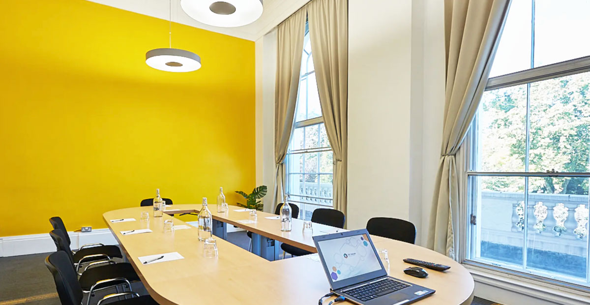 Bright Fitzrovia conference room with modern AV setup, laptop connectivity, and natural light, listed on Conveenie
