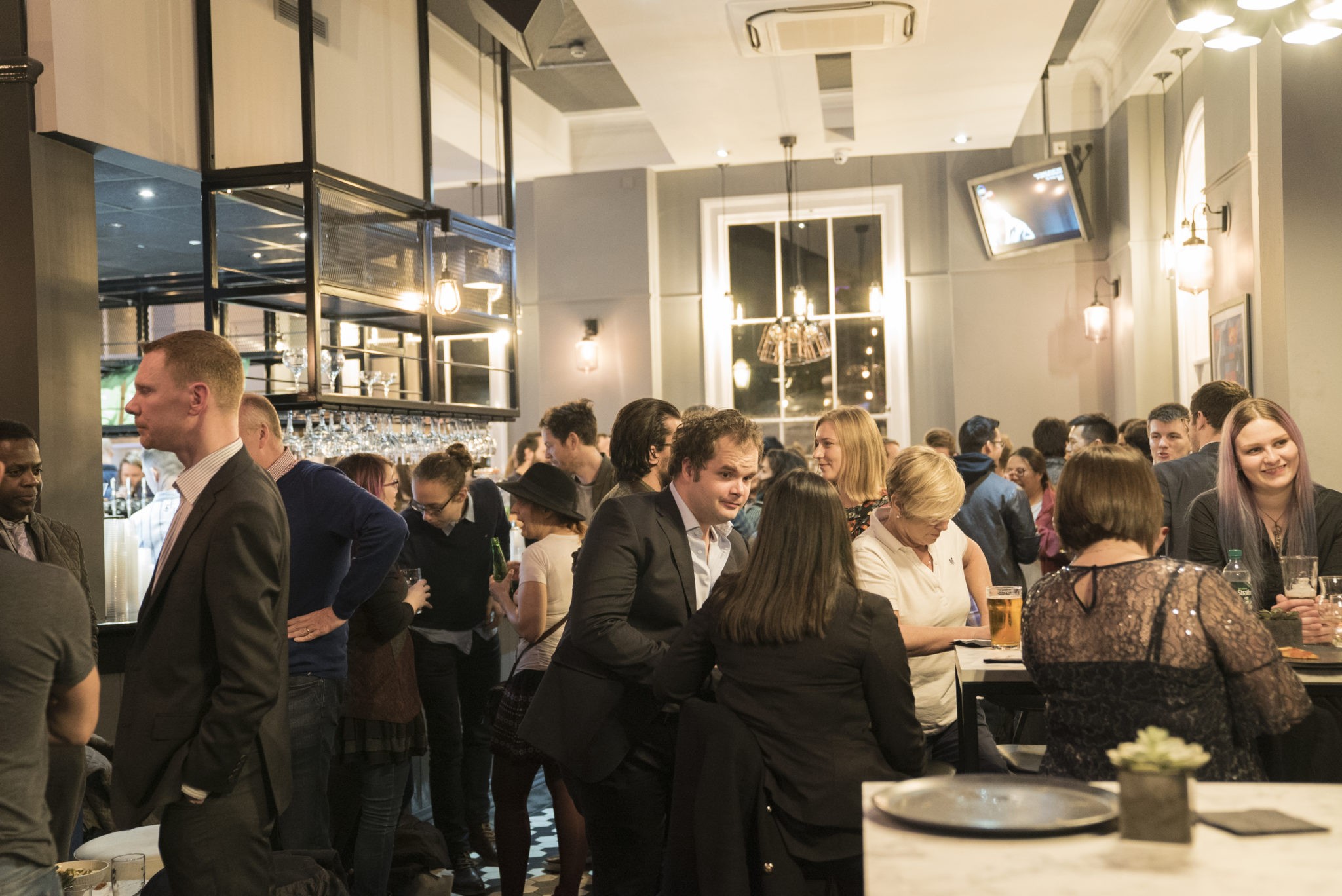 Guests networking at The Thirsty Scholar Marylebone cafe-bar, a versatile London venue hire for corporate and social events 