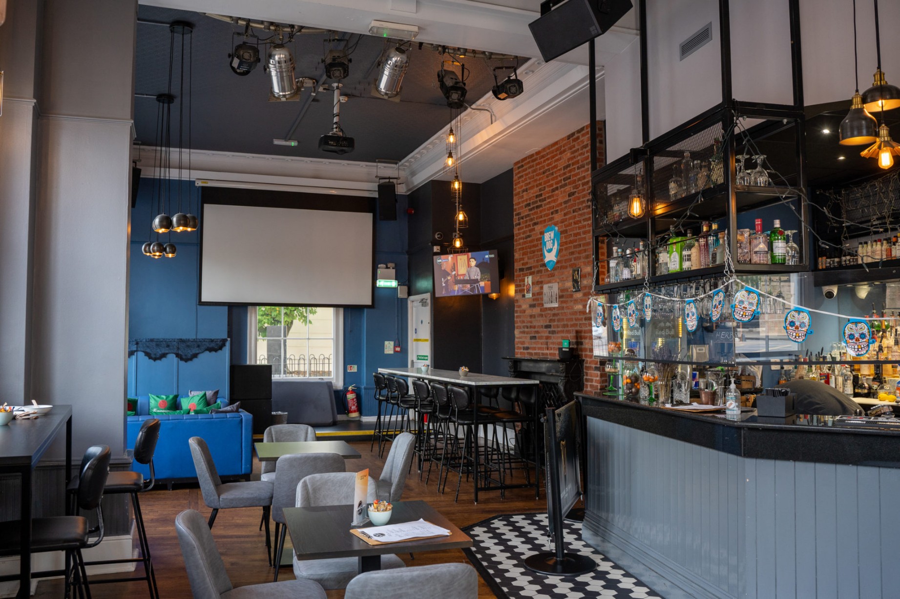 Stylish Marylebone cafe-bar interior with exposed brick, bar seating and projection screen, available for private hire via Conveenie