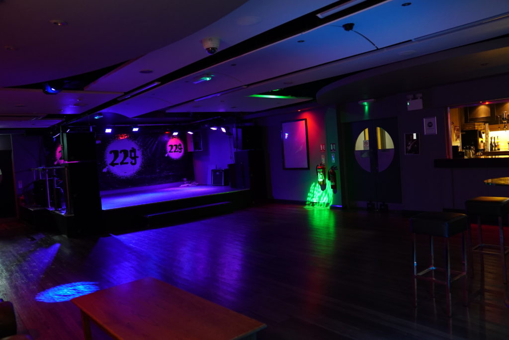 Venue 2 at ISH Venues London lit with green neon stage lighting, ideal for club nights and private party hire in central London