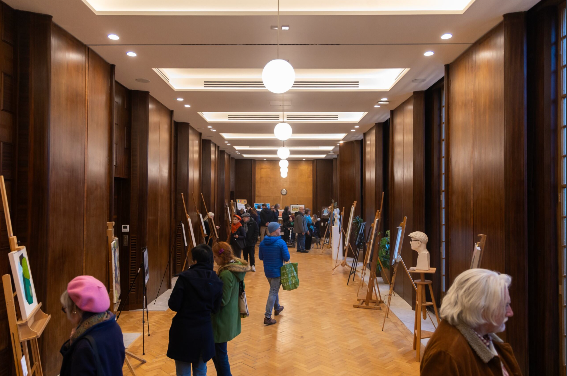 Guests browsing an art showcase in the Committee Room at Hornsey Town Hall, an adaptable North London venue for exhibitions and receptions