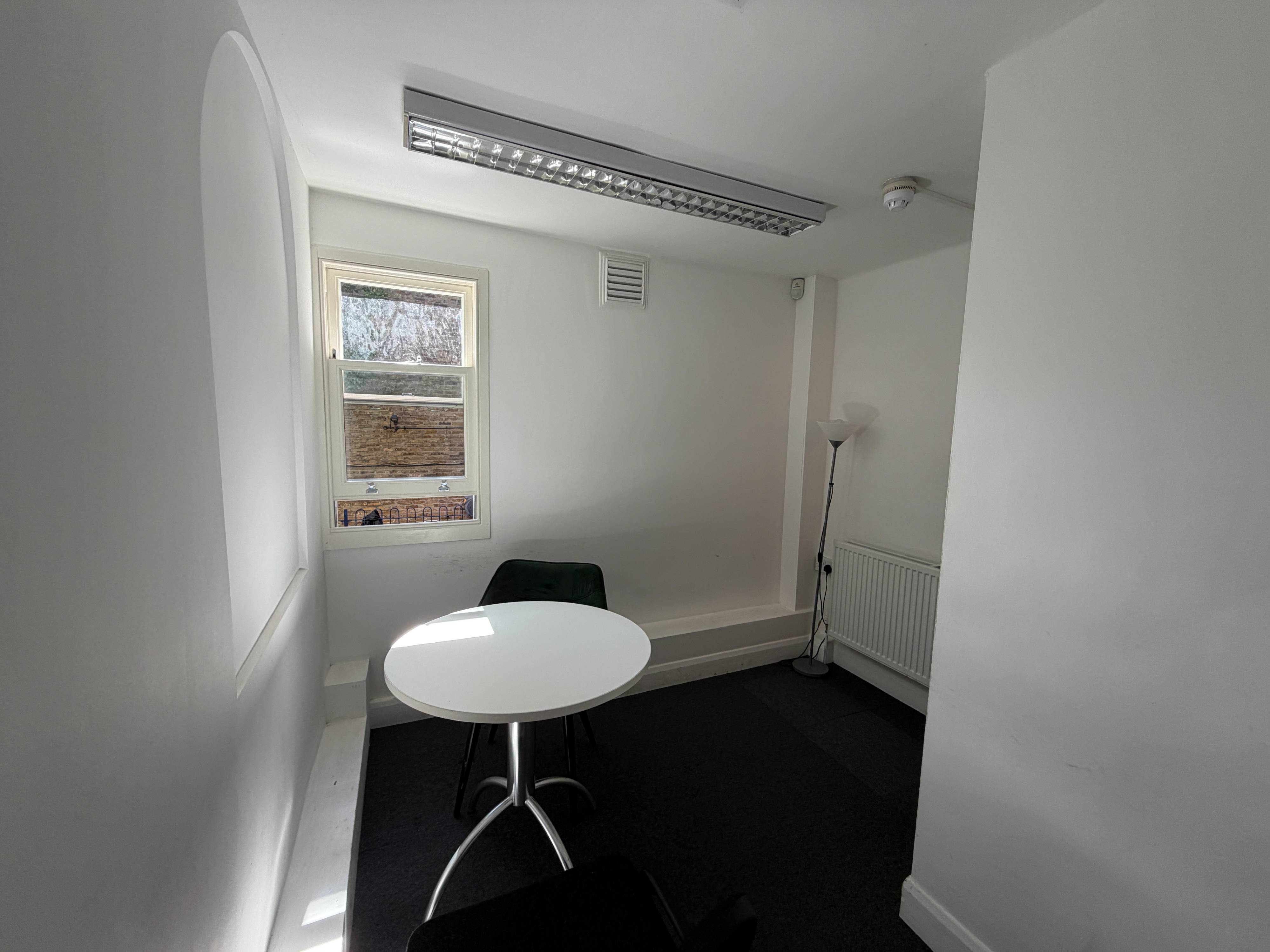Therapy Room at Centre 404 with round table, chairs and window overlooking trees