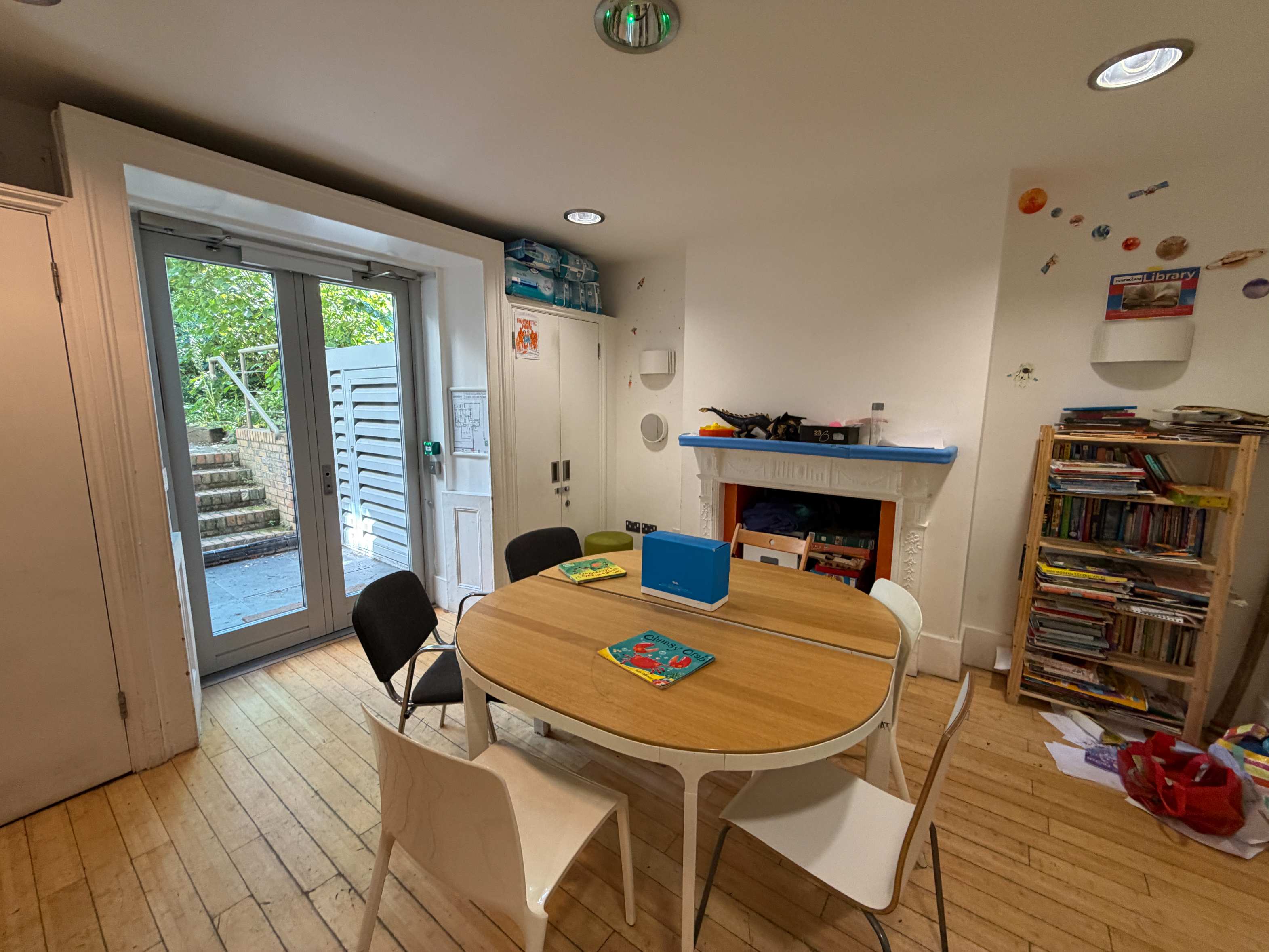 Meeting Room at Centre 404 with wooden table, chairs and doors opening onto the garden
