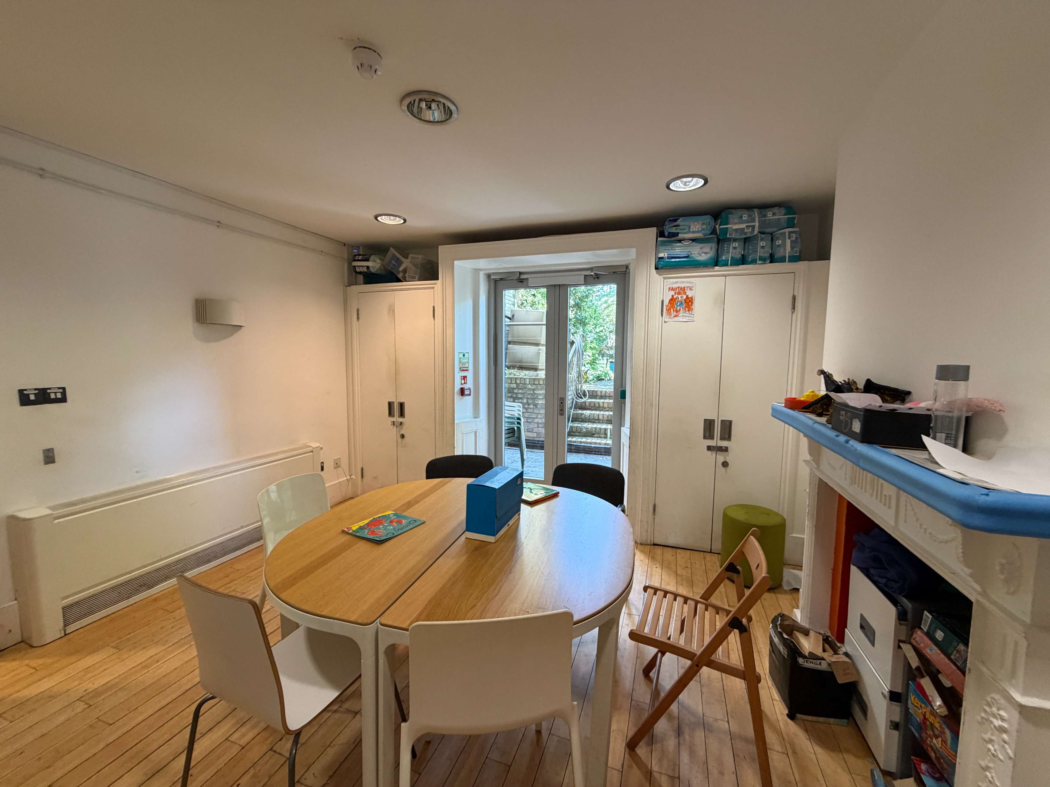 Meeting Room at Centre 404 with dining table, fireplace and garden-facing doors