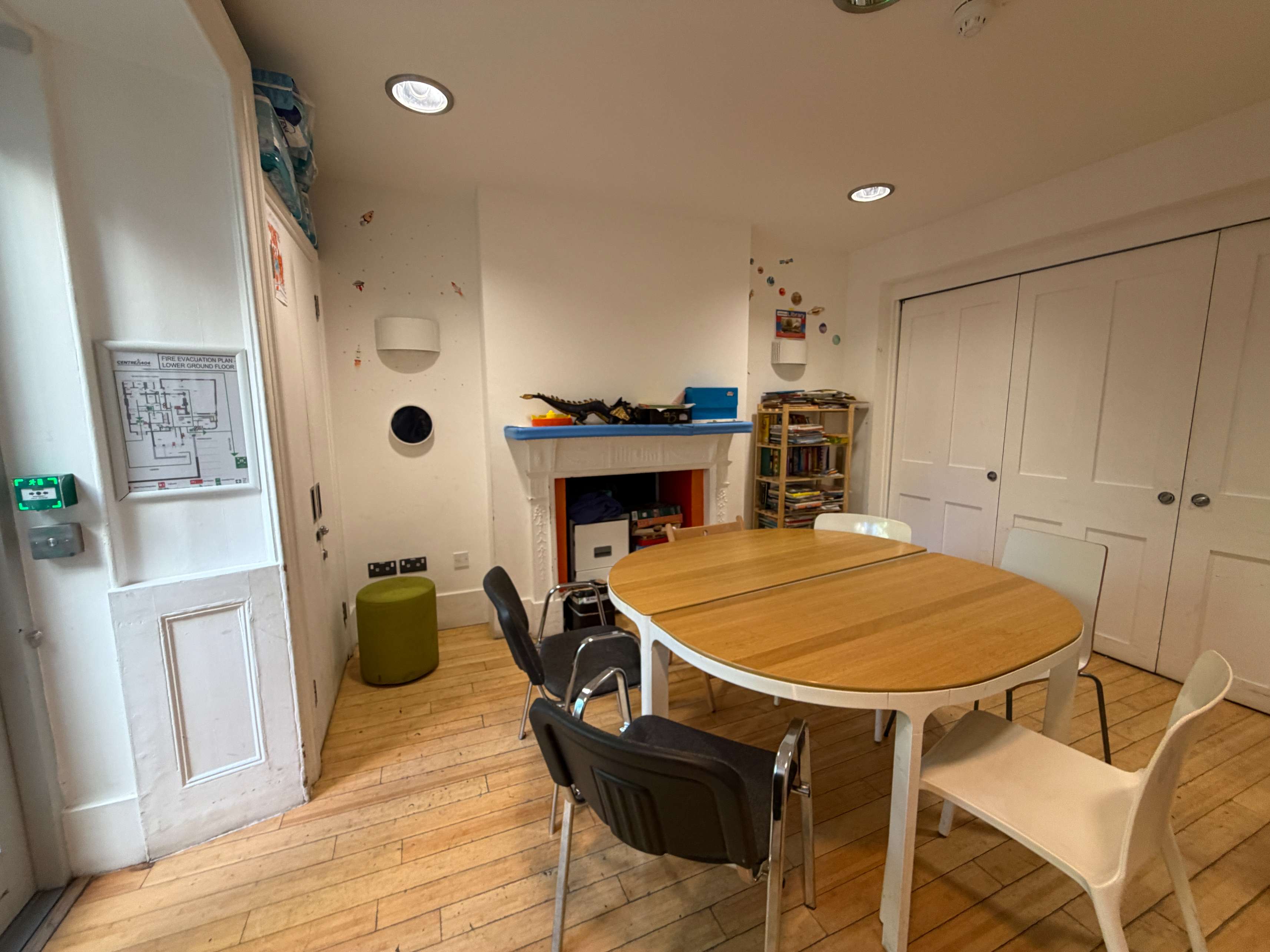 Meeting Room at Centre 404 with wooden table, chairs and fireplace feature