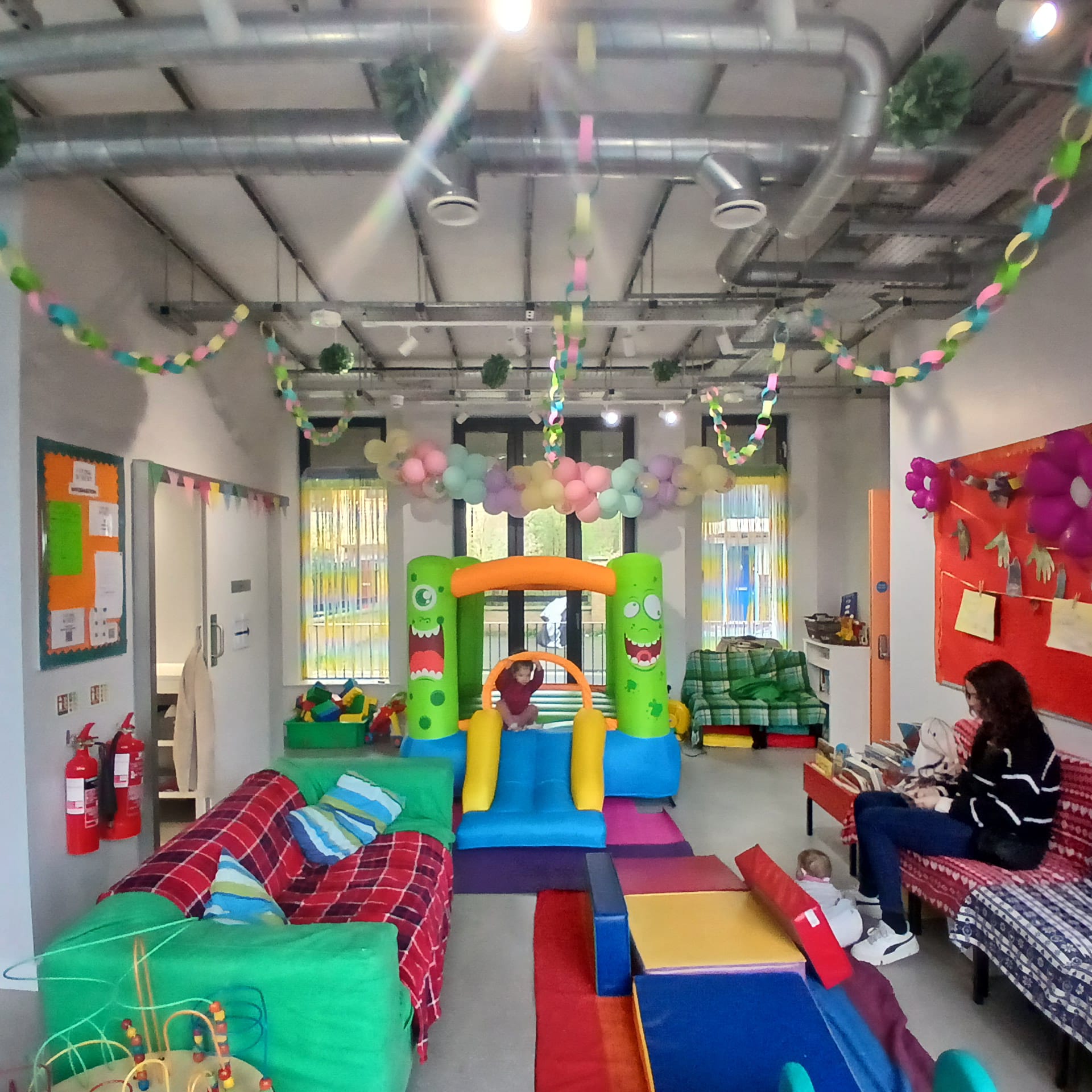 Open hall at the Allie Harper Room at Ivy Street Family Centre set up with a bouncy castle, perfect for children's parties and active events.