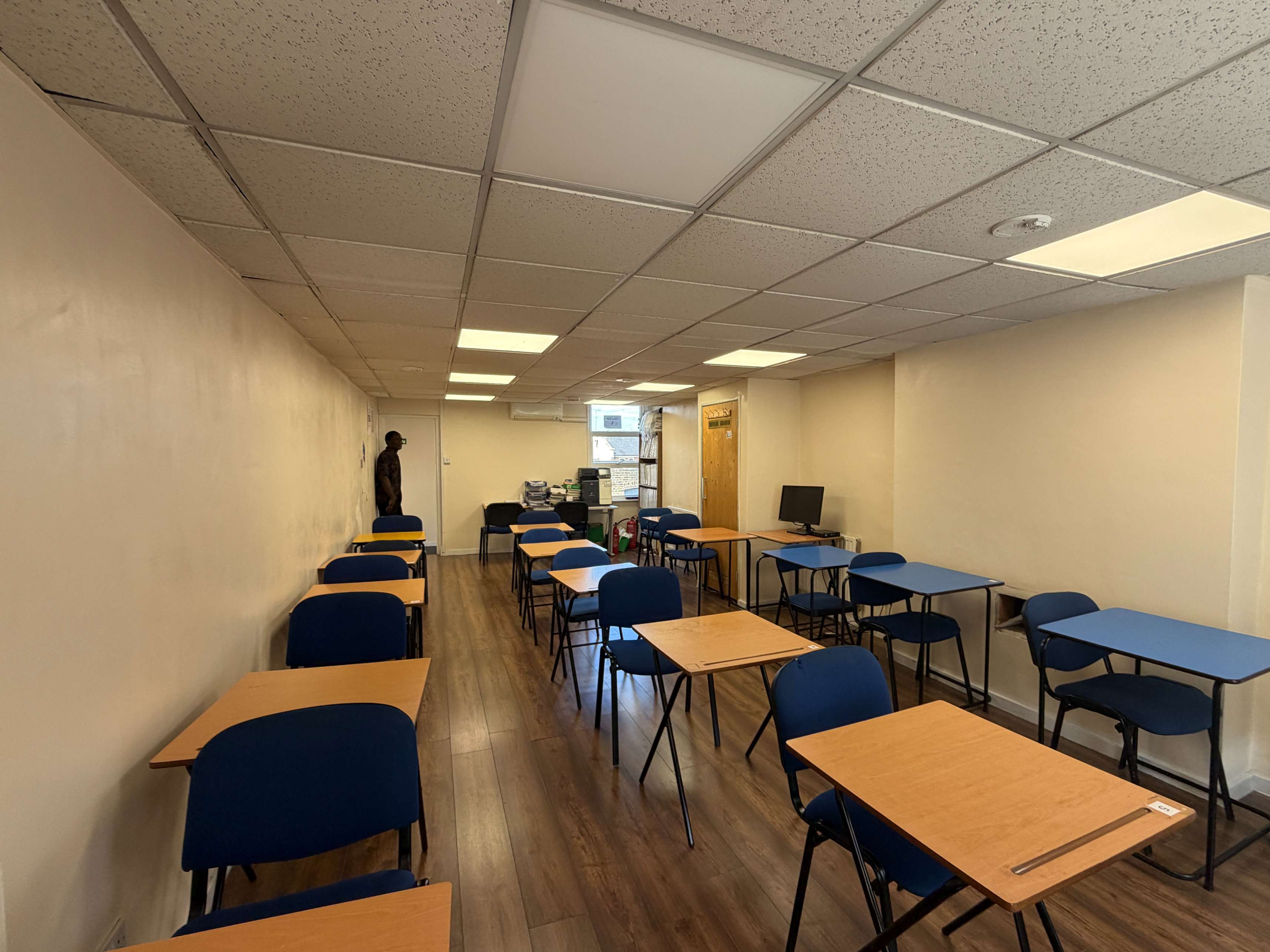 The School Room at Centre 404, Walworth — rows of desks and chairs in a bright community classroom