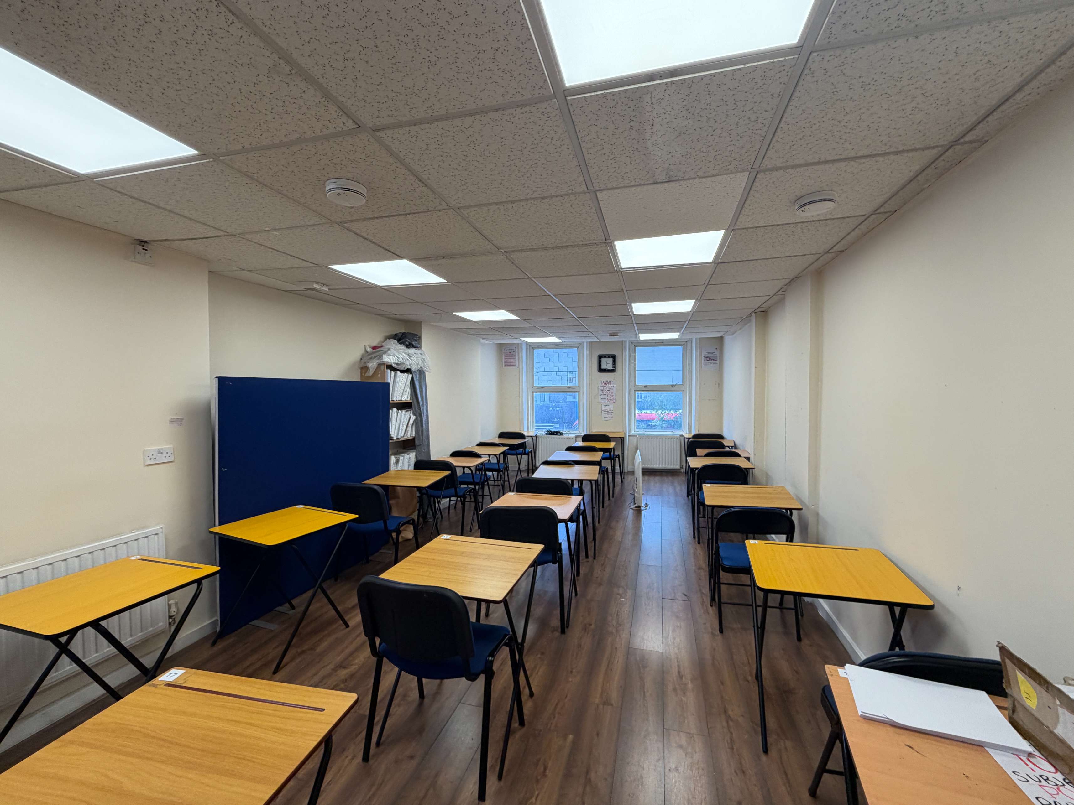 Interior view of The School Room, Walworth — individual desks with chairs facing the front of the room