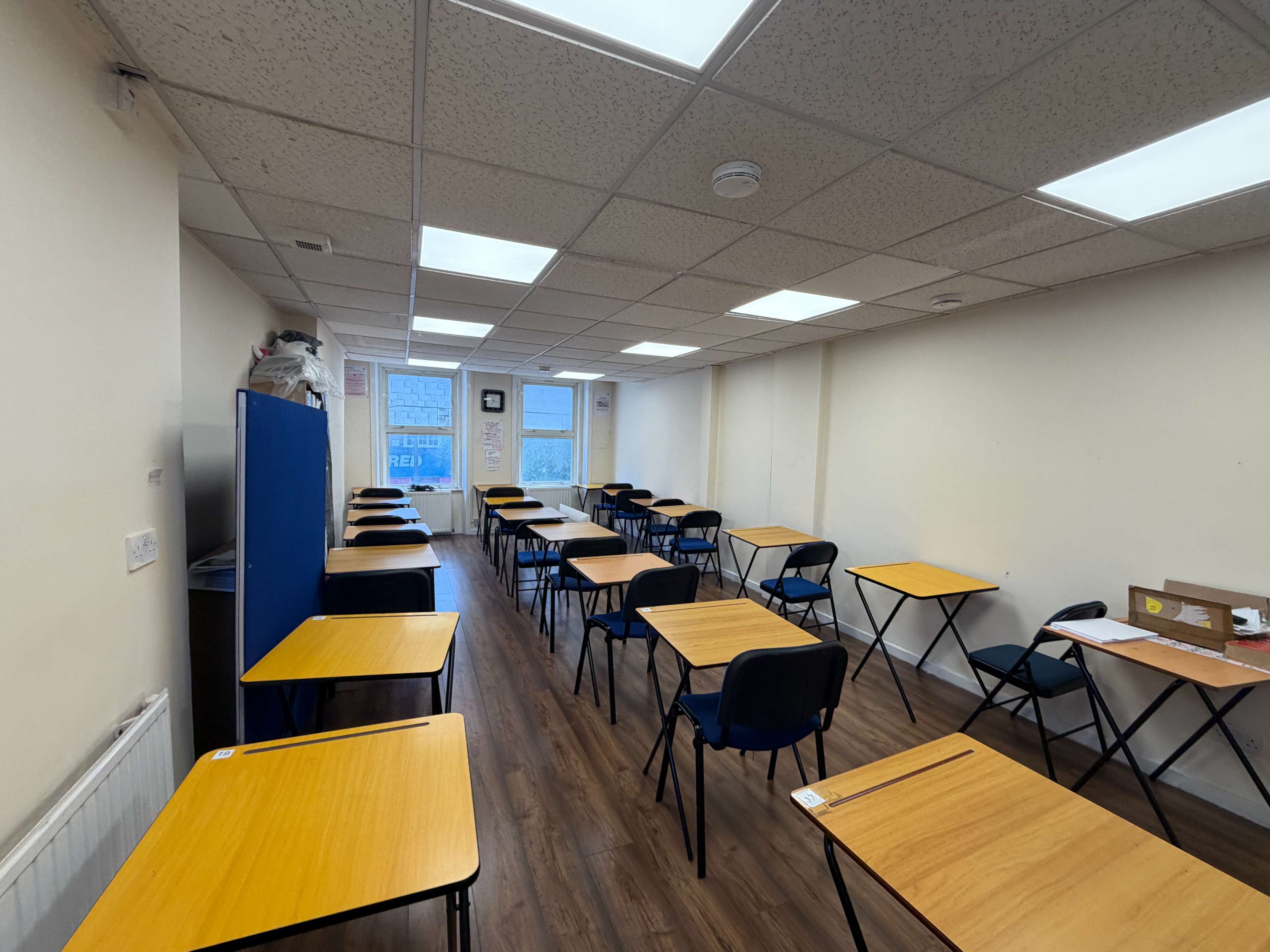 Interior view of The School Room, Walworth — individual desks with chairs facing the front of the room