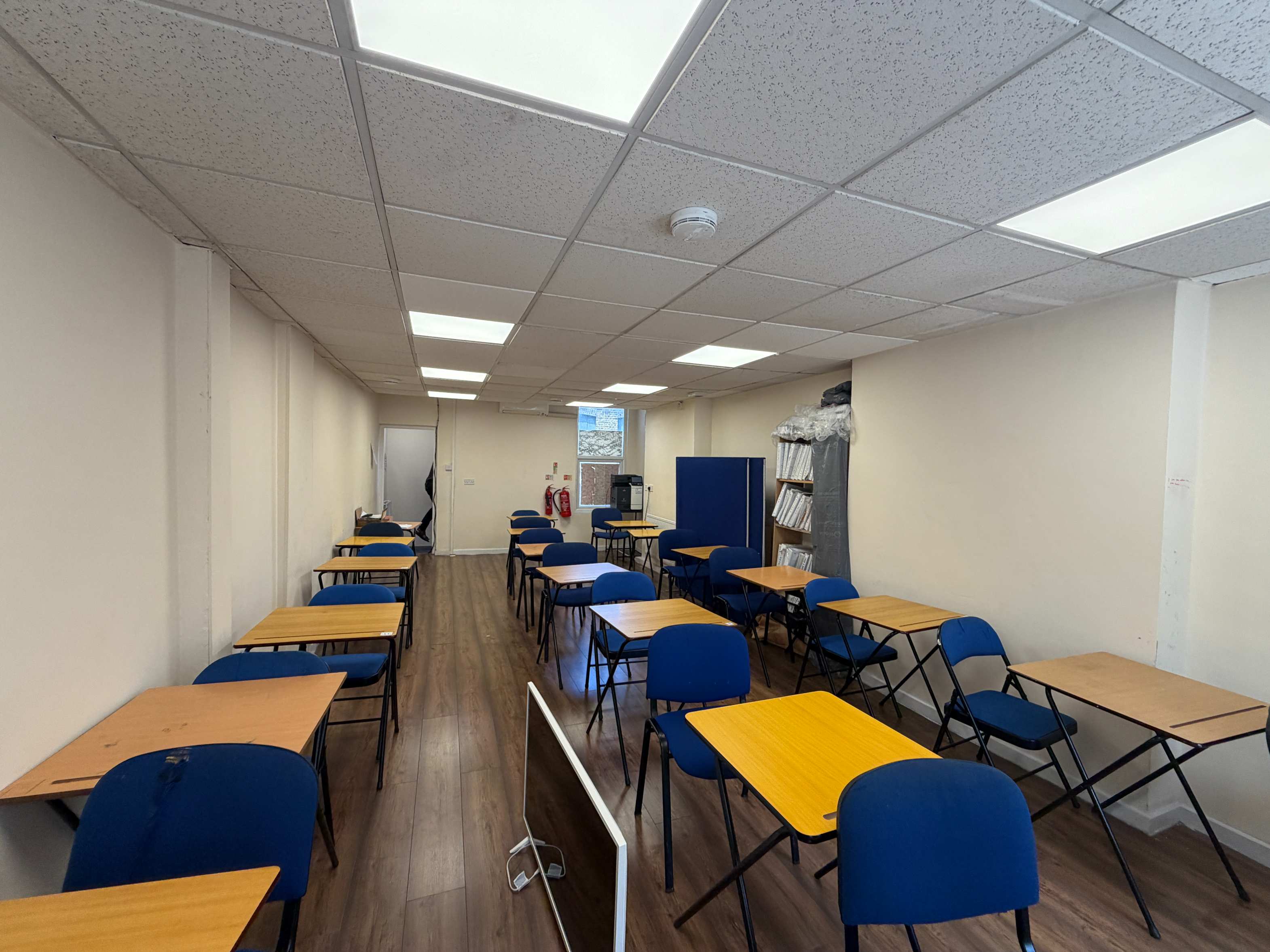 Wide view of The School Room, Walworth — classroom-style seating with wood-effect flooring
