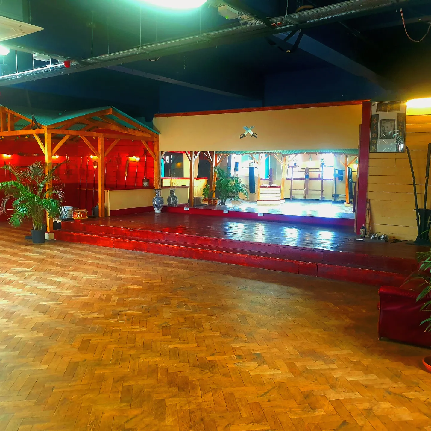 Zhulin Hidden Village in Lewisham, London set up with warm red lighting and an open dance floor, creating an atmospheric setting for events, classes, 