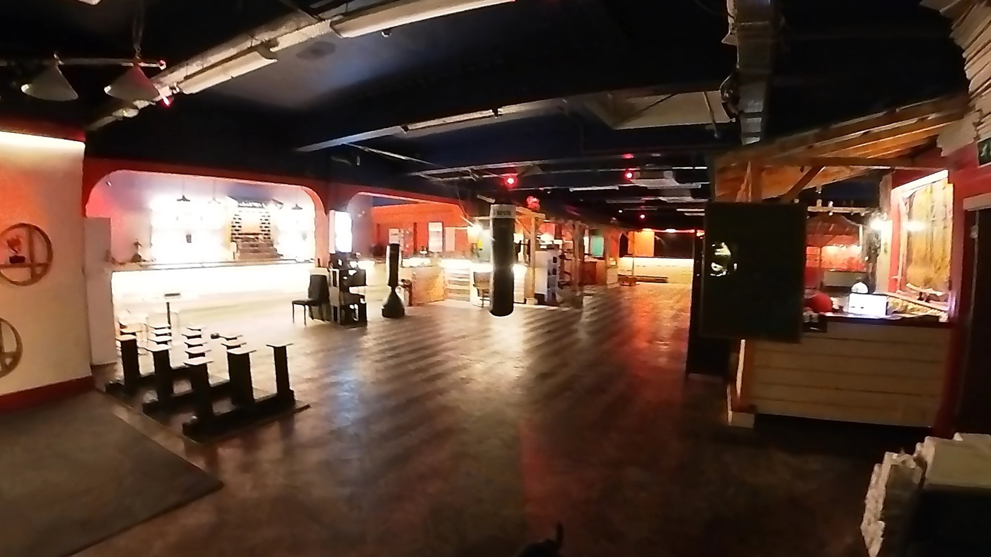 Interior of Zhulin Hidden Village showing the open plan event space with dark ceilings and ambient lighting, ideal for martial arts classes, dance eve