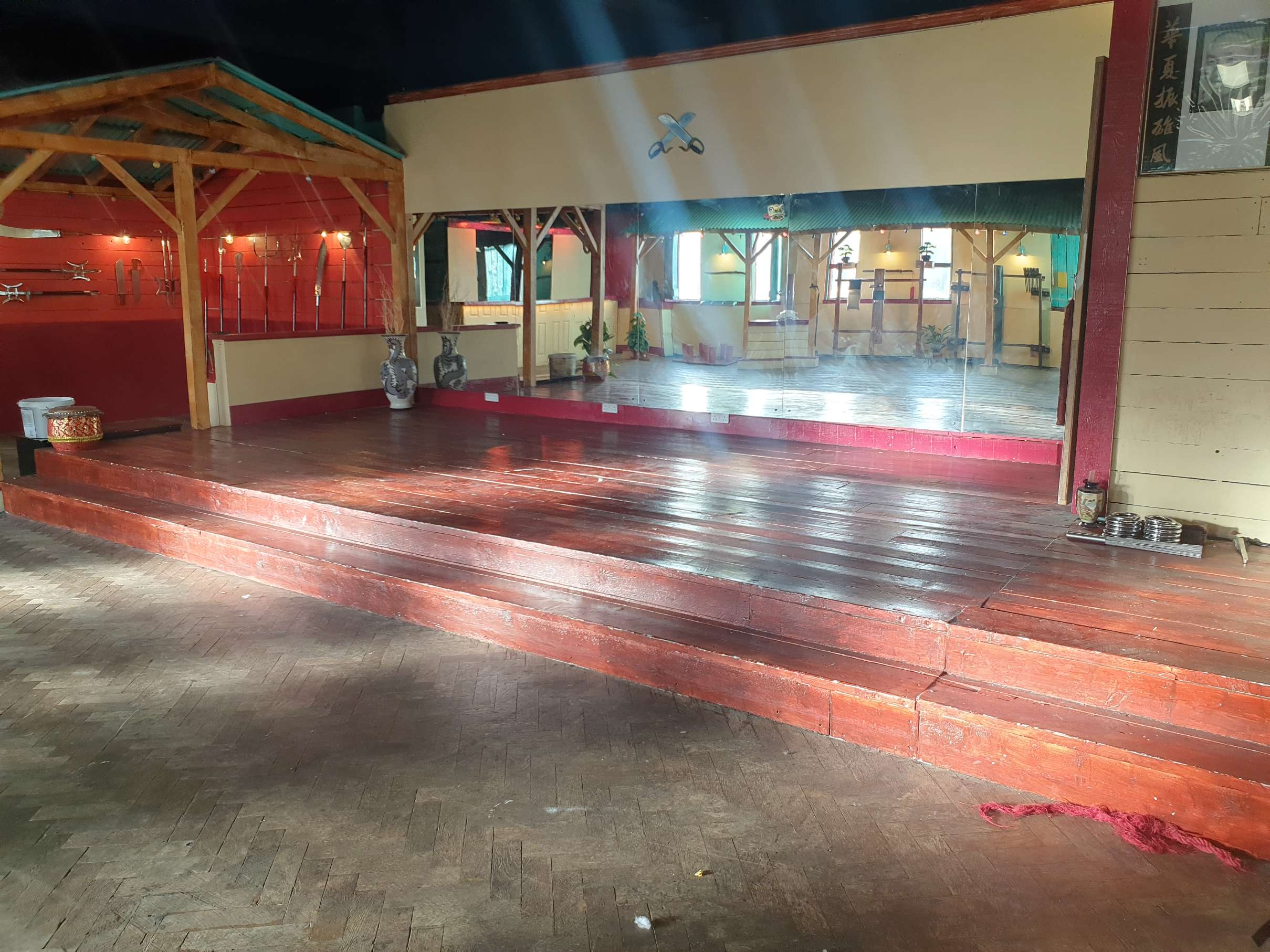 Zhulin Hidden Village in Lewisham illuminated with red and blue stage lighting across the open event floor, perfect for nightlife events, dance perfor