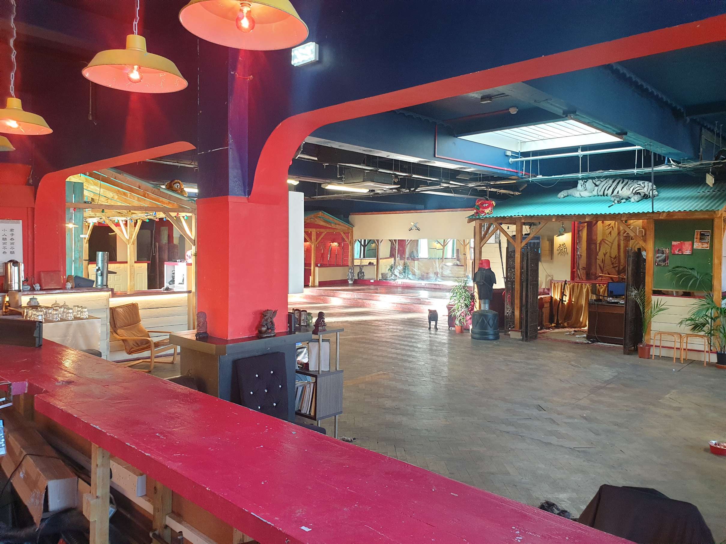 Red pillar and atmospheric interior of Zhulin Hidden Village in South East London, reflecting the venue's distinctive Chinese cultural theme and uniqu