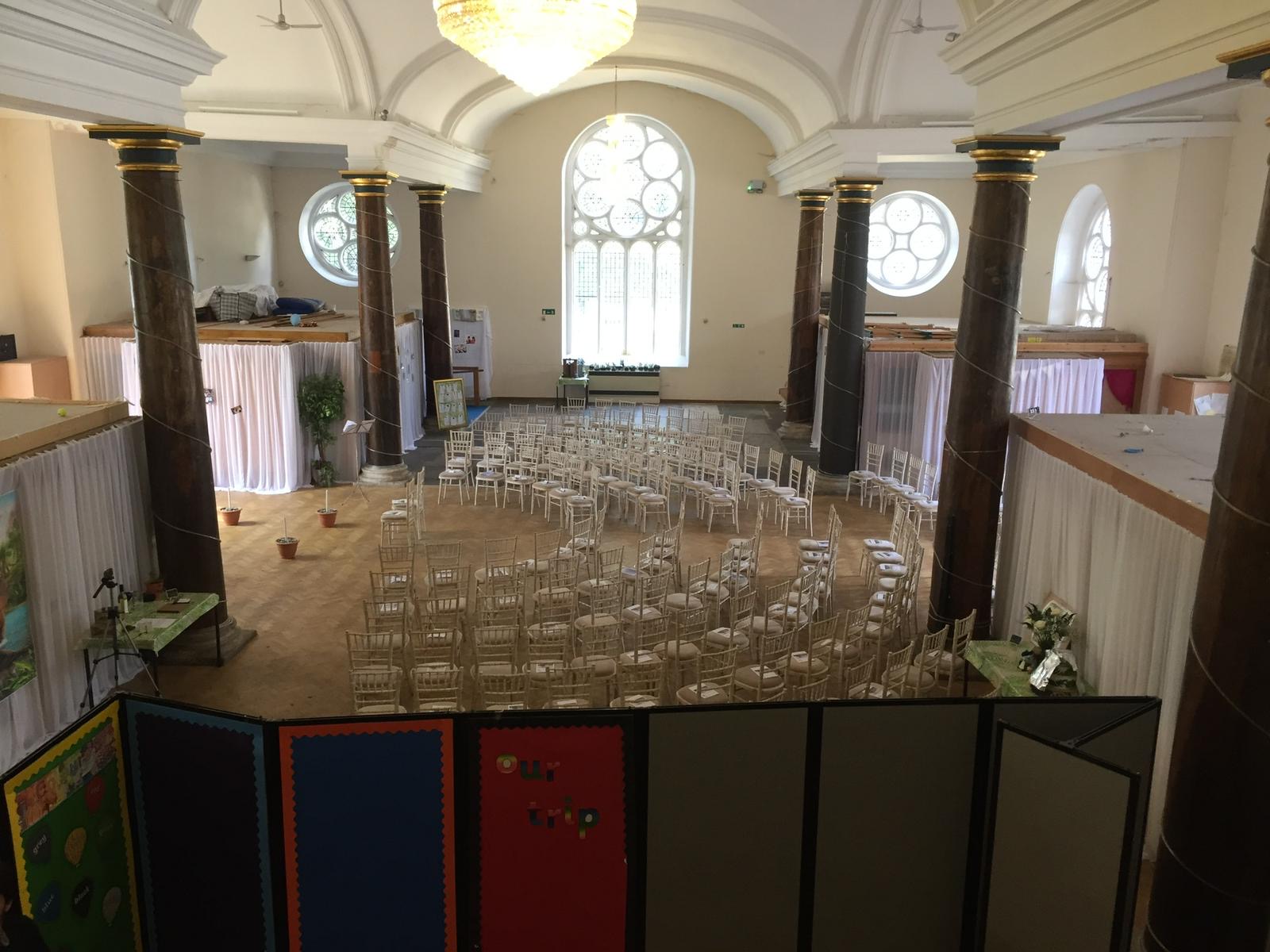 St Matthias Church Hall in London set up theatre style with rows of chairs beneath vaulted ceilings and stained glass windows, ideal for conferences, 