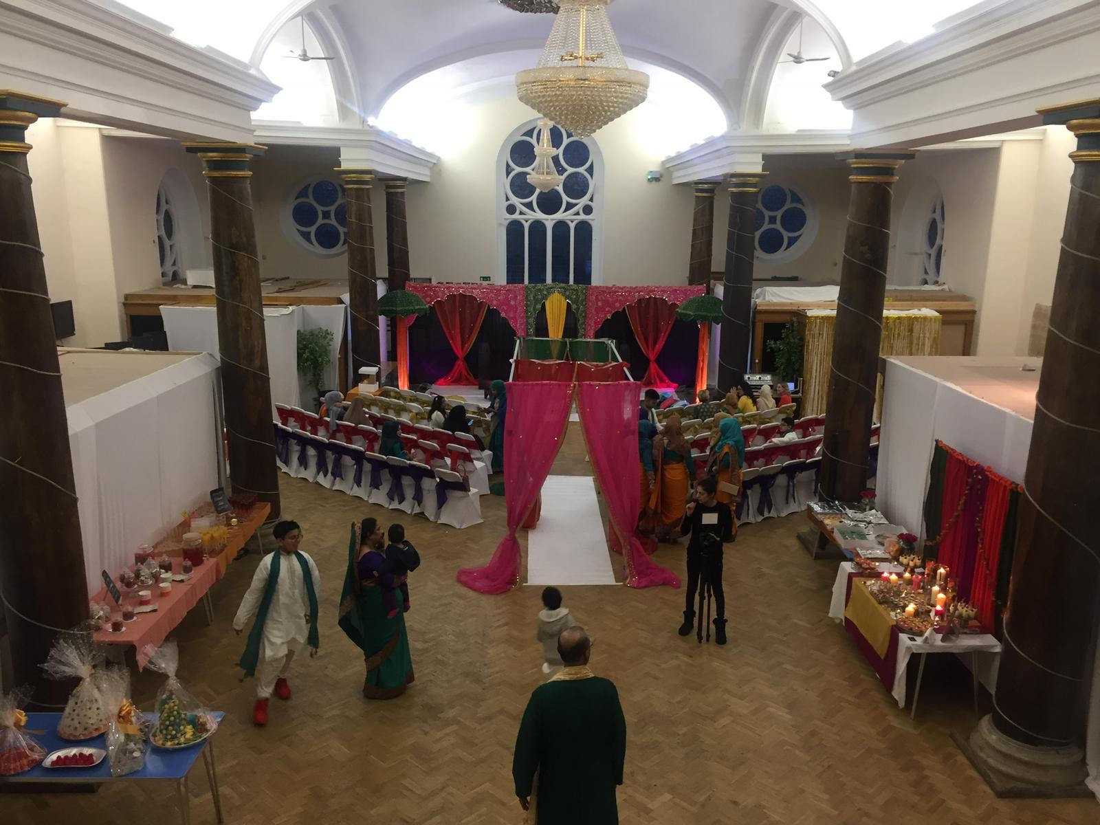 St Matthias Church Hall decorated with vibrant coloured drapes and festive displays, showcasing the versatility of this unique London event space for 