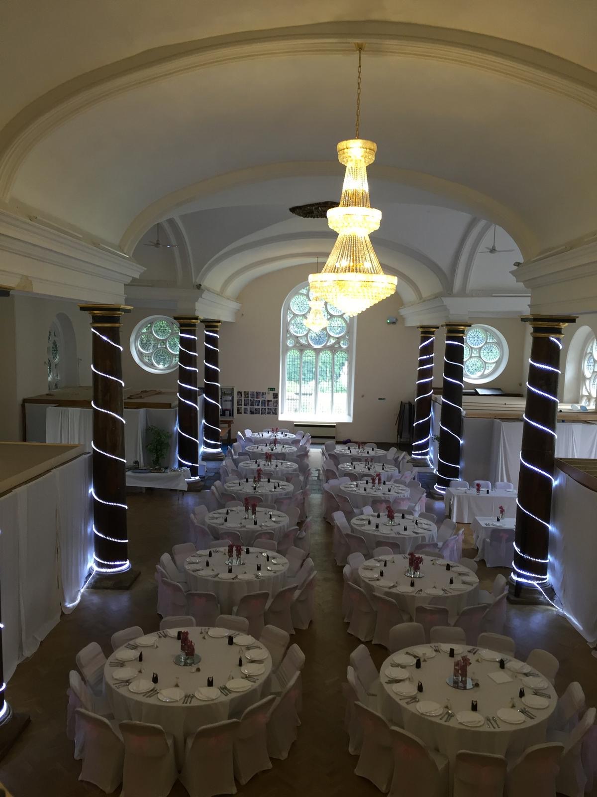 St Matthias Church Hall dressed with crystal candelabras and elegant table settings beneath the vaulted stone ceiling, creating a magical atmosphere f