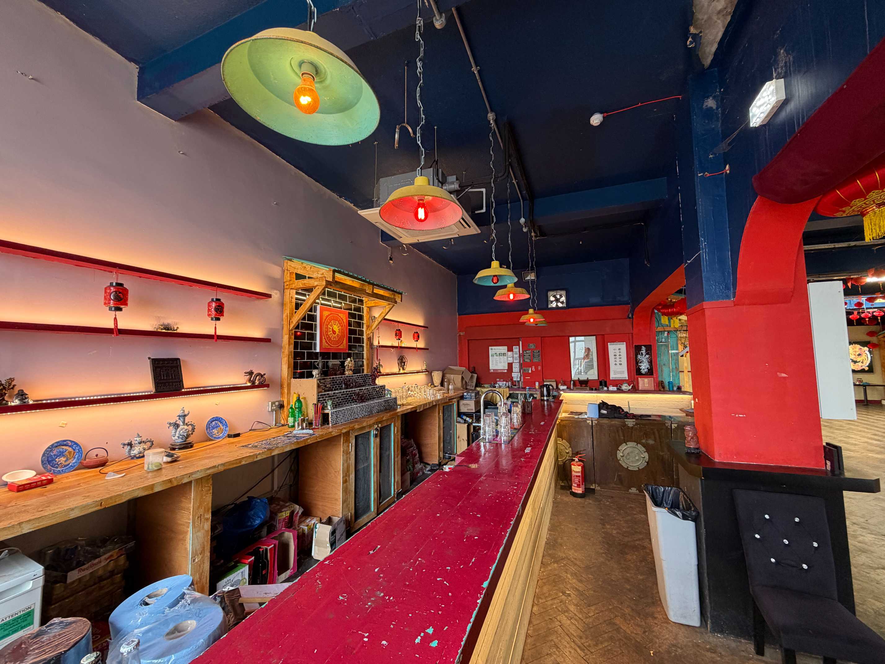 Zhulin Hidden Village oriental-themed lounge and bar area with red counter, warm lighting, and Chinese decor