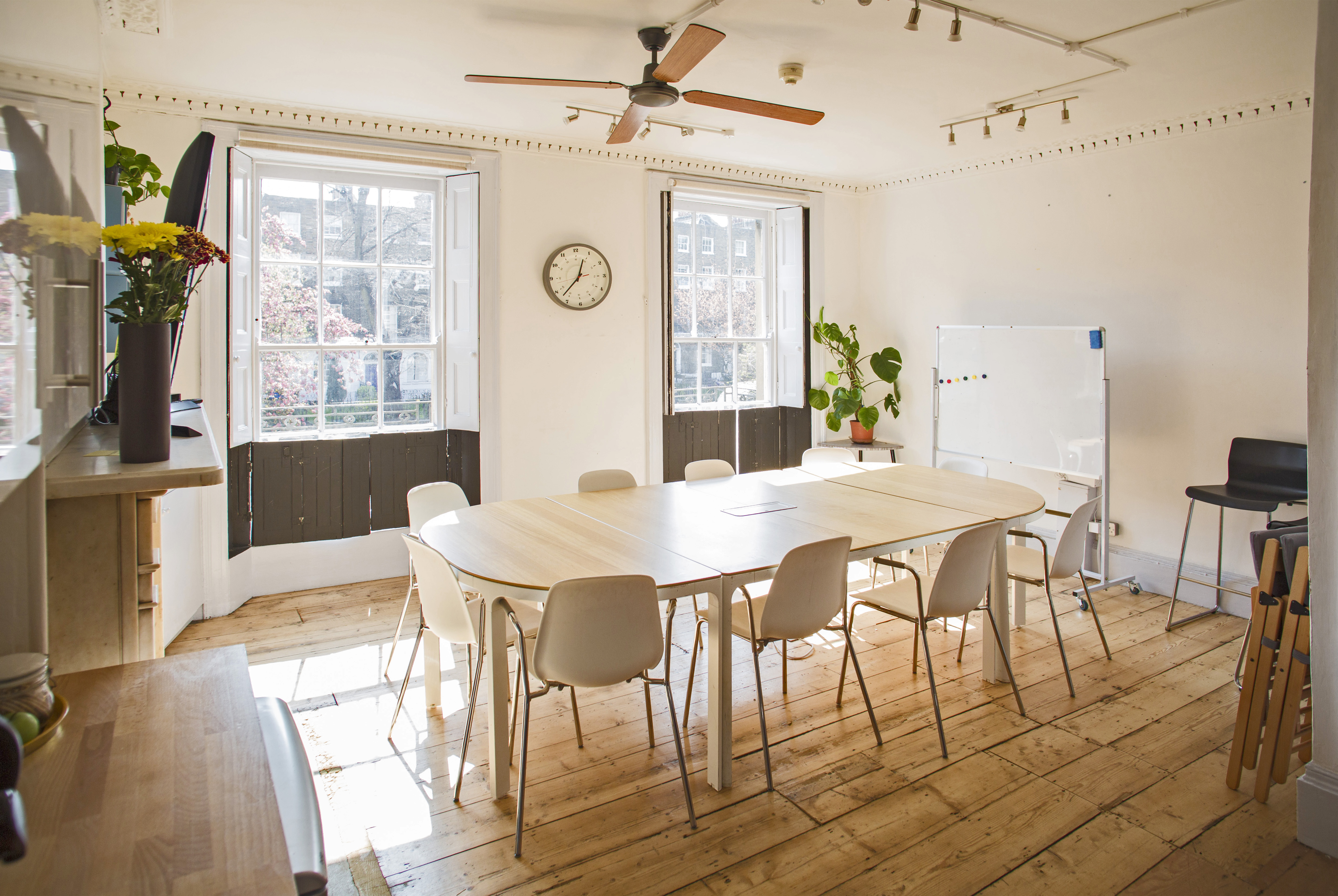 The Office at Anomalous Space, London, a bright meeting room for 15 with wooden floors and a large whiteboard, book via Conveenie.