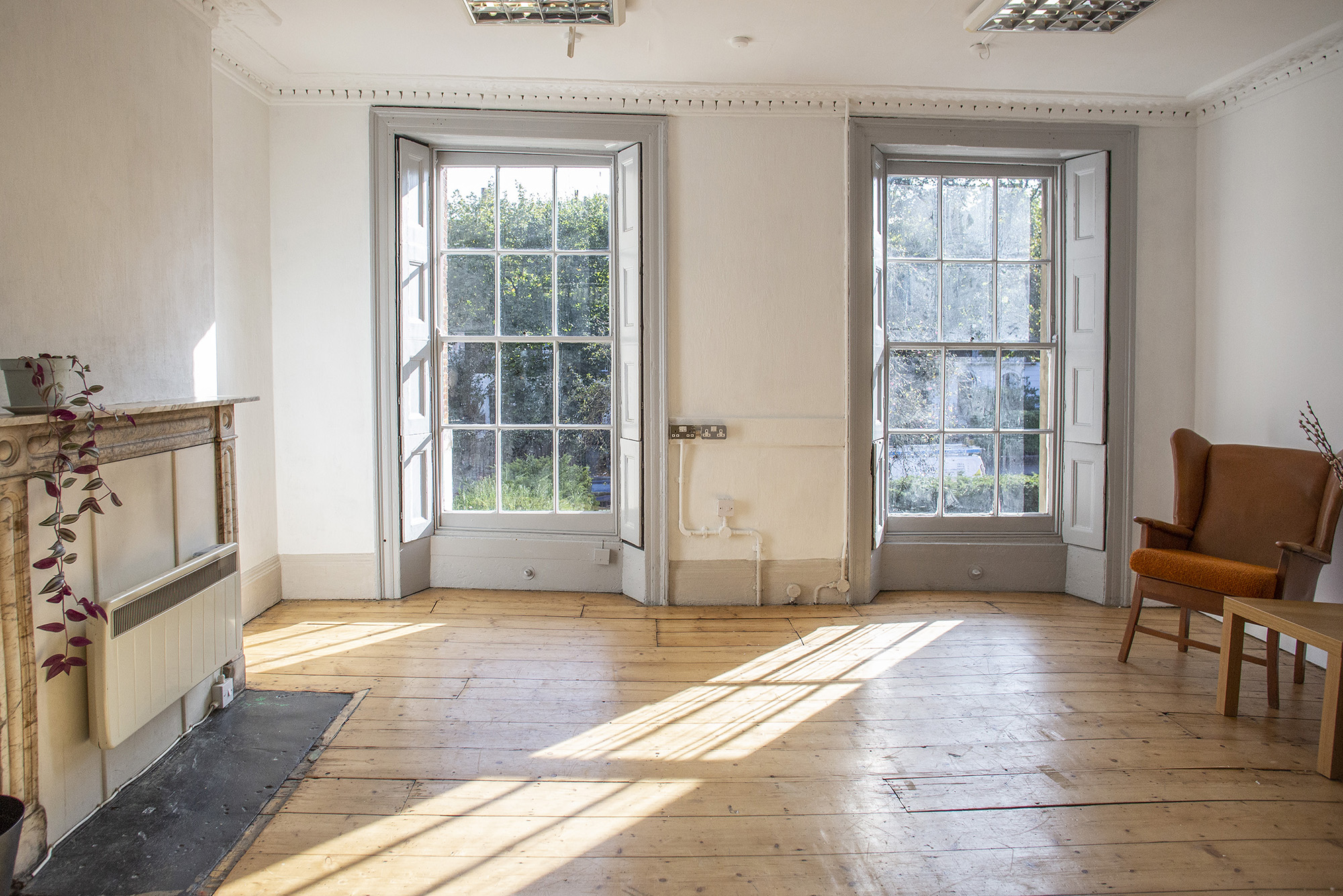 Sun-drenched Studio at Anomalous Space in London, a bright photo shoot studio with tall sash windows and natural wood floor.