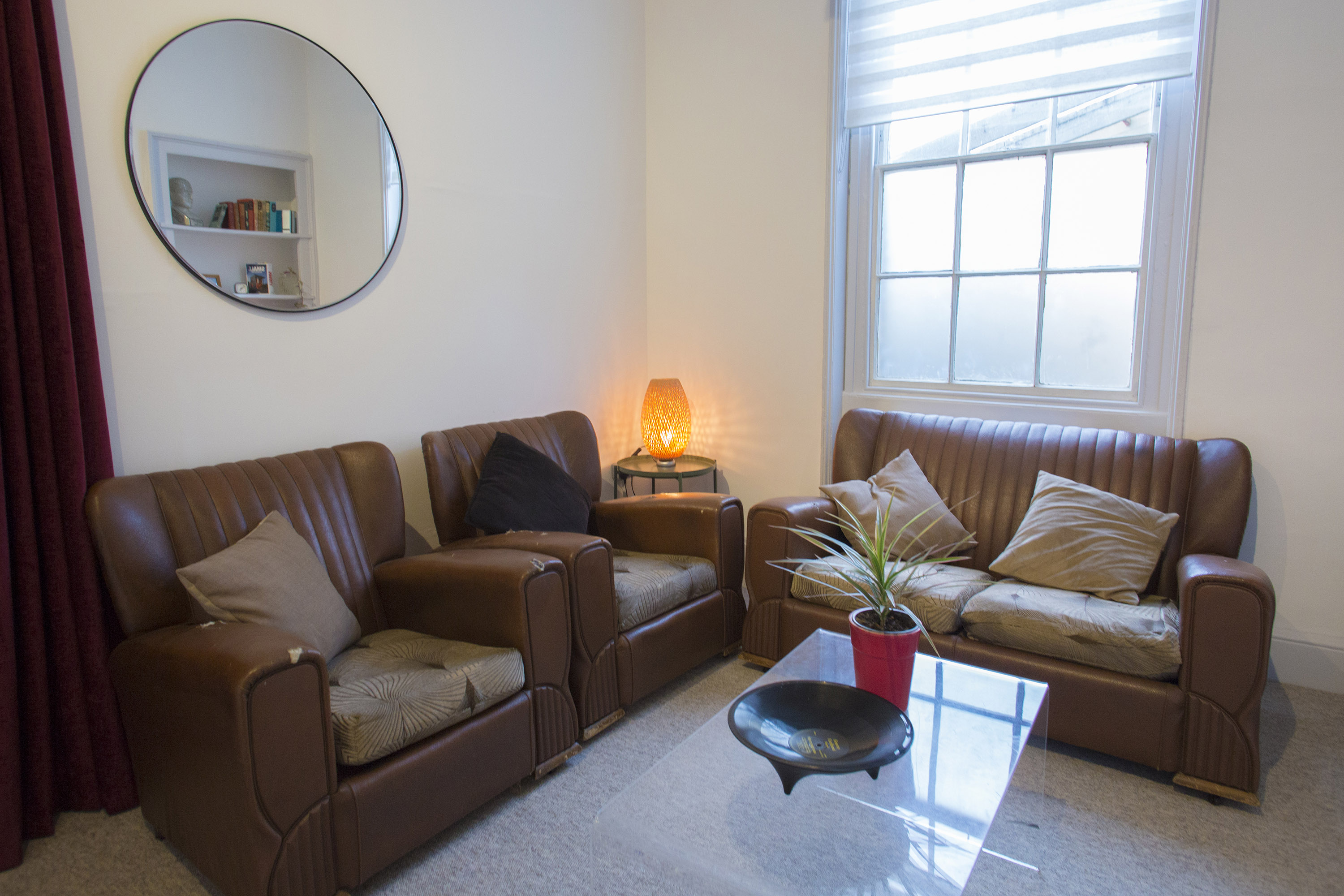 Cosy breakout area in The Flat, Anomalous Space in Islington, London, featuring comfortable leather seating, a perfect space rental for events.