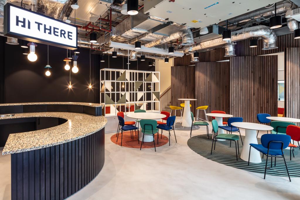 The modern cafe at Melanin Health & Wellness, which houses the 35-capacity studio, curved bar, and colorful seating.