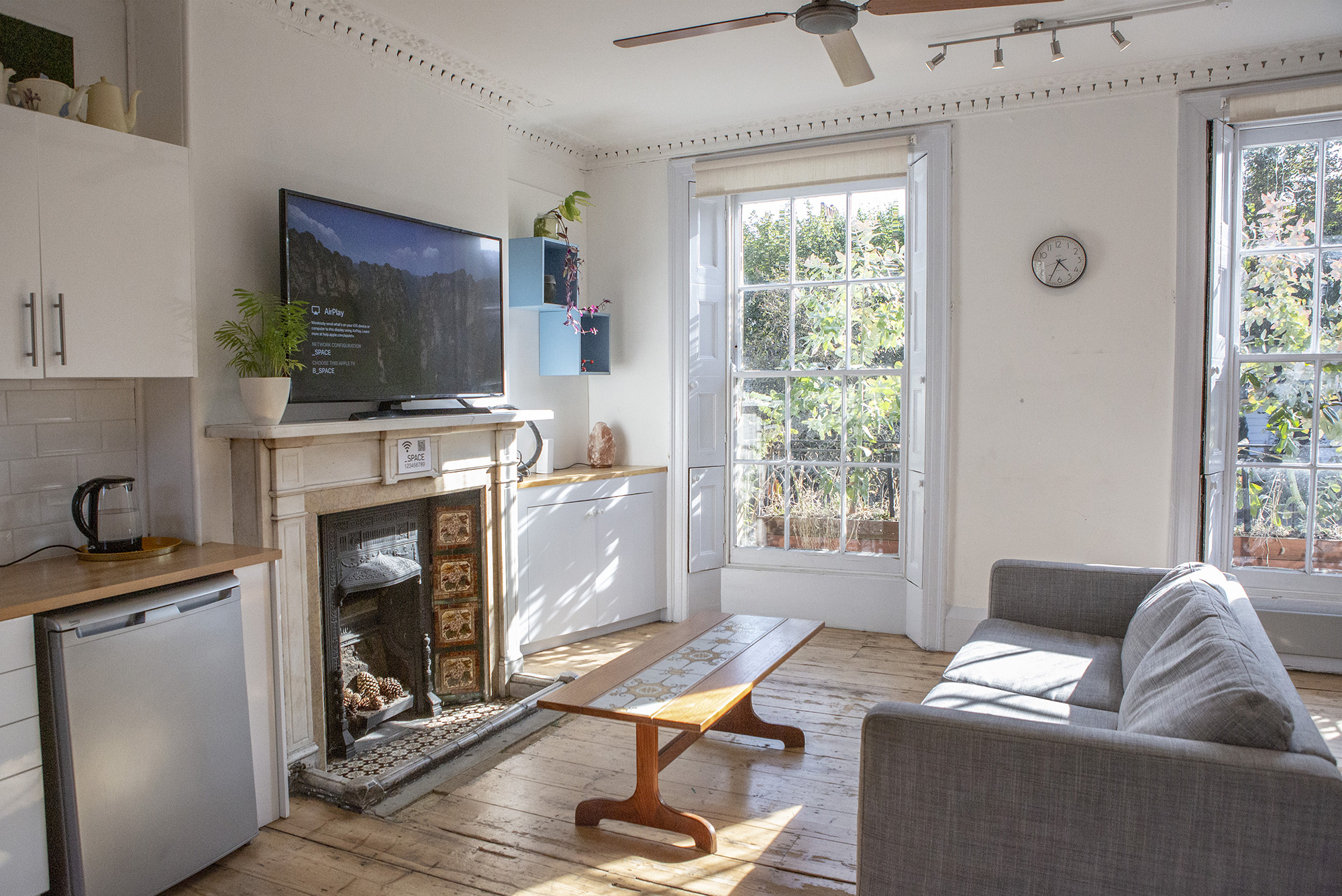Bright meeting room hire in London at The Office, Anomalous Space, with a TV, fireplace, and mini-kitchenette, a welcoming space.