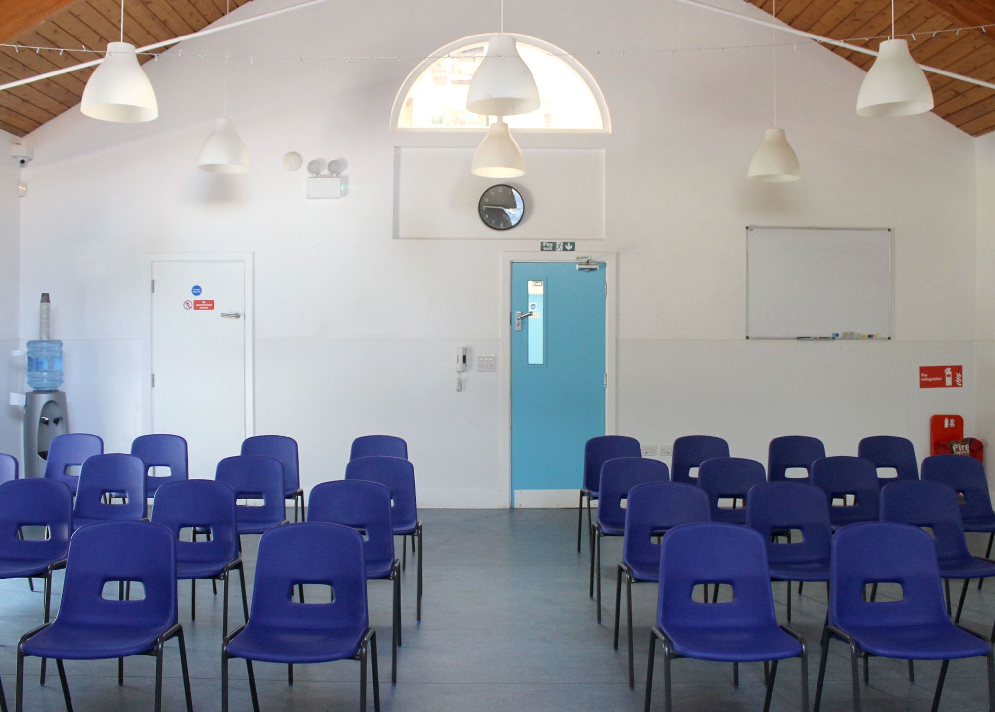 Seating setup with tables in Devas Garden Room—ideal for meetings, receptions, or private parties.