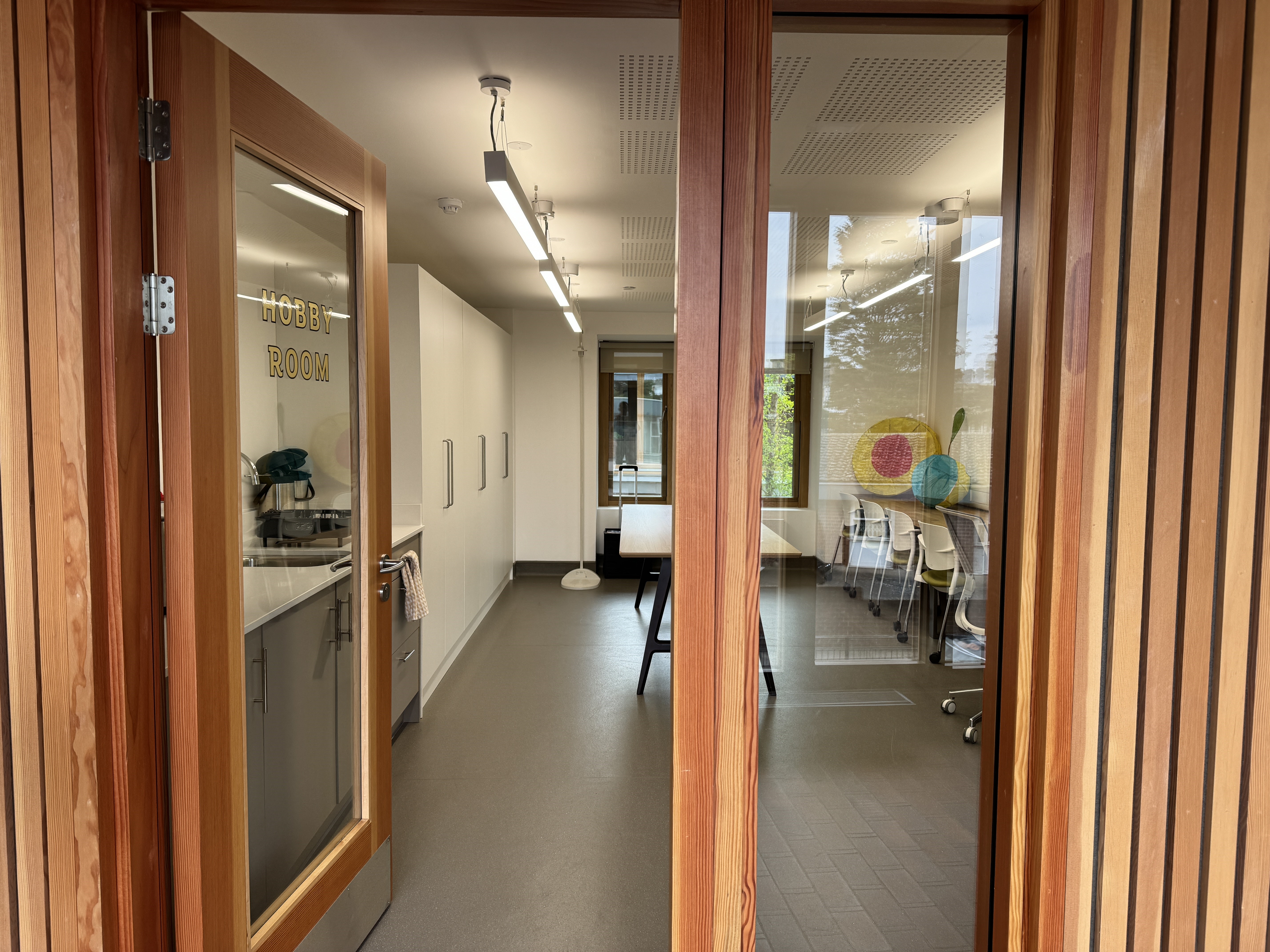 Hobby Room at Appleby Blue in London, an ideal room hire in London for crafts and meetings for 16 people, with a kitchenette visible from the entrance