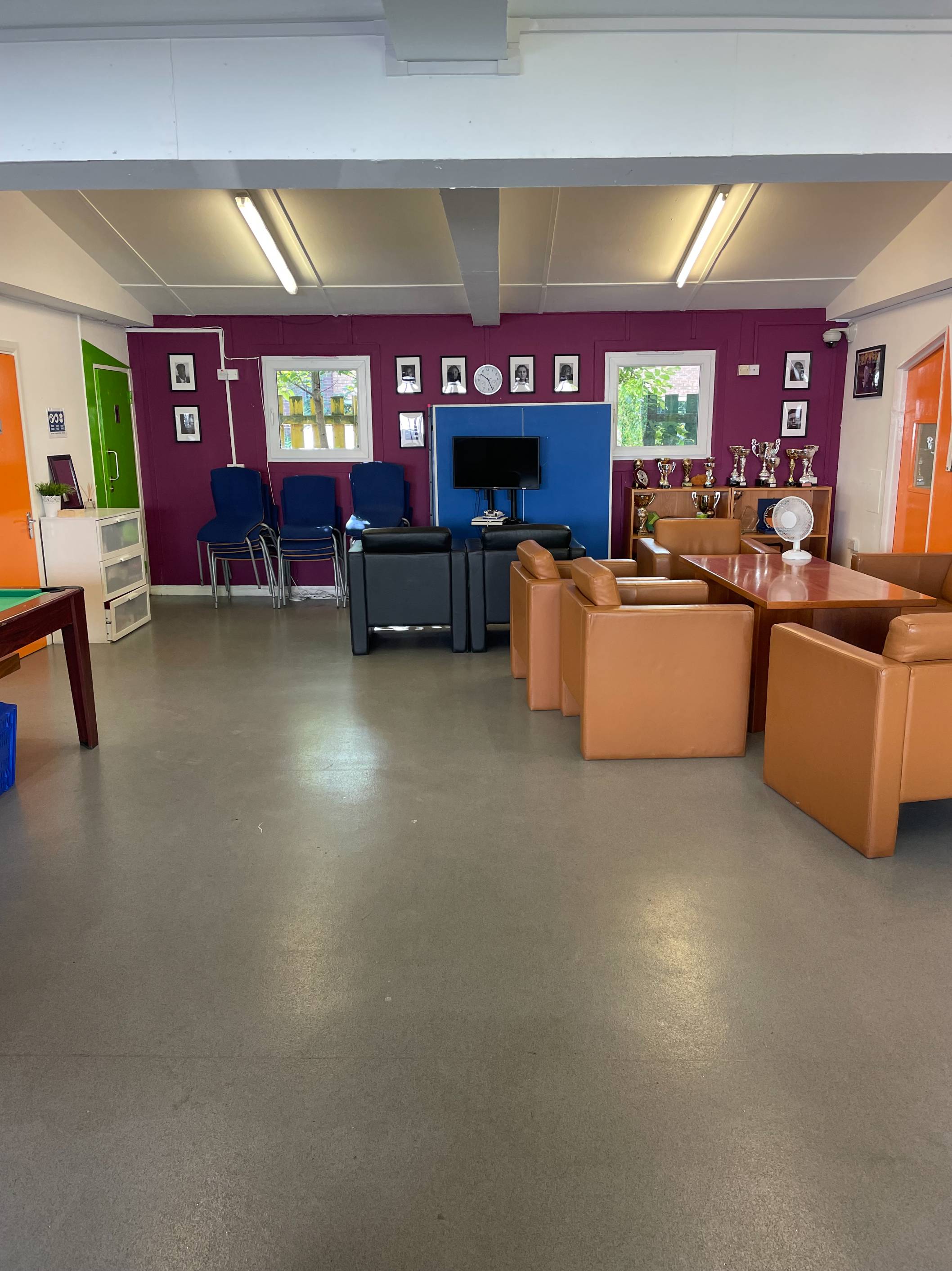 Main room interior at Dexters featuring cosy sofas, pool table and a spacious layout for community events