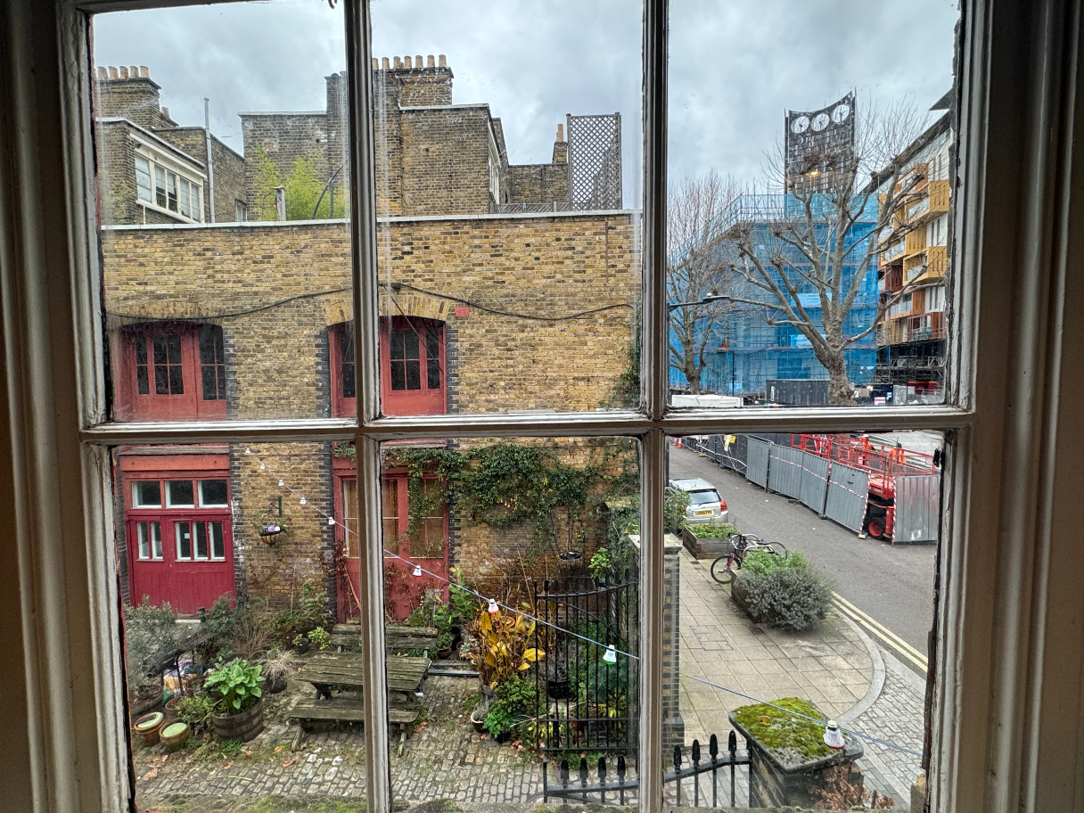 Comfortable upstairs room with wooden floors and natural light in Pullens Yards, available via Conveenie