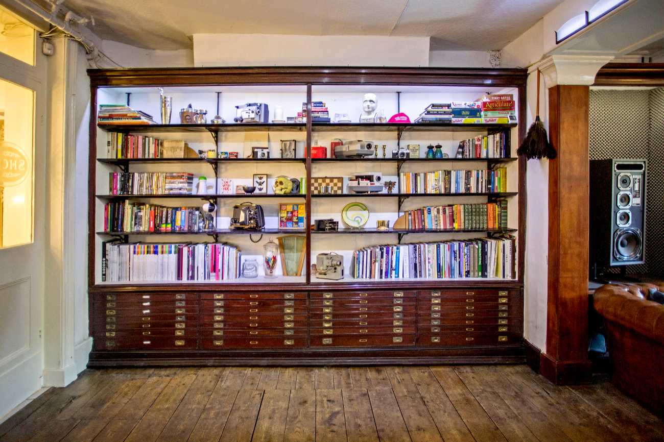 Large, unique bookcase feature wall in The Home, Anomalous Space in London, a well-decorated small venue for hire.