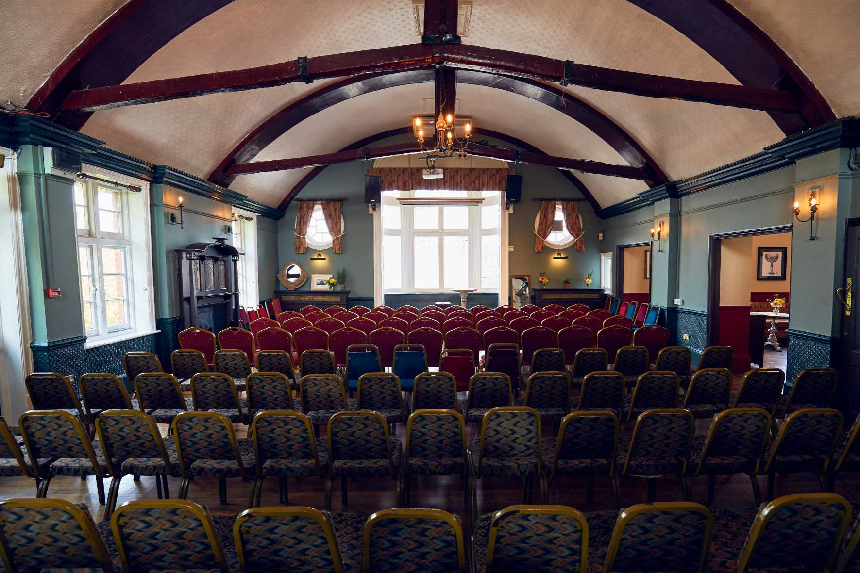 Interior view of The Royal Oak’s first floor in New Malden, featuring high ceilings and warm vintage decor.
