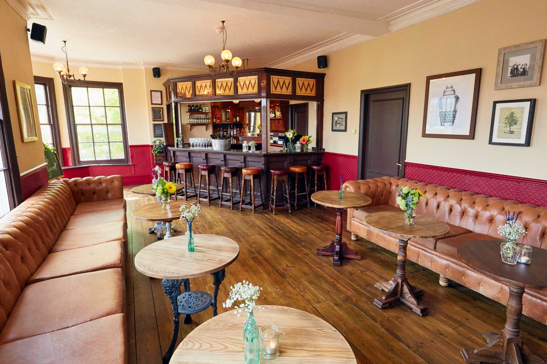 Soft ambient lighting and cozy sofas create an inviting event space at The Royal Oak in New Malden.