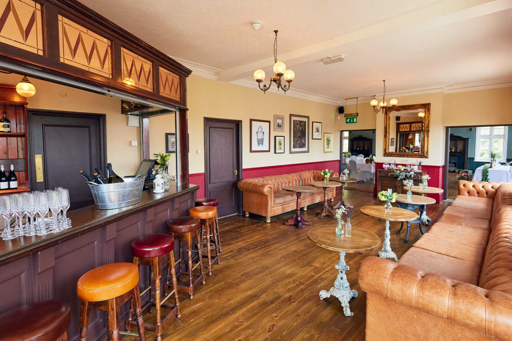 Bar and plush sofa seating offer a relaxed corner for mingling at this versatile New Malden event space.
