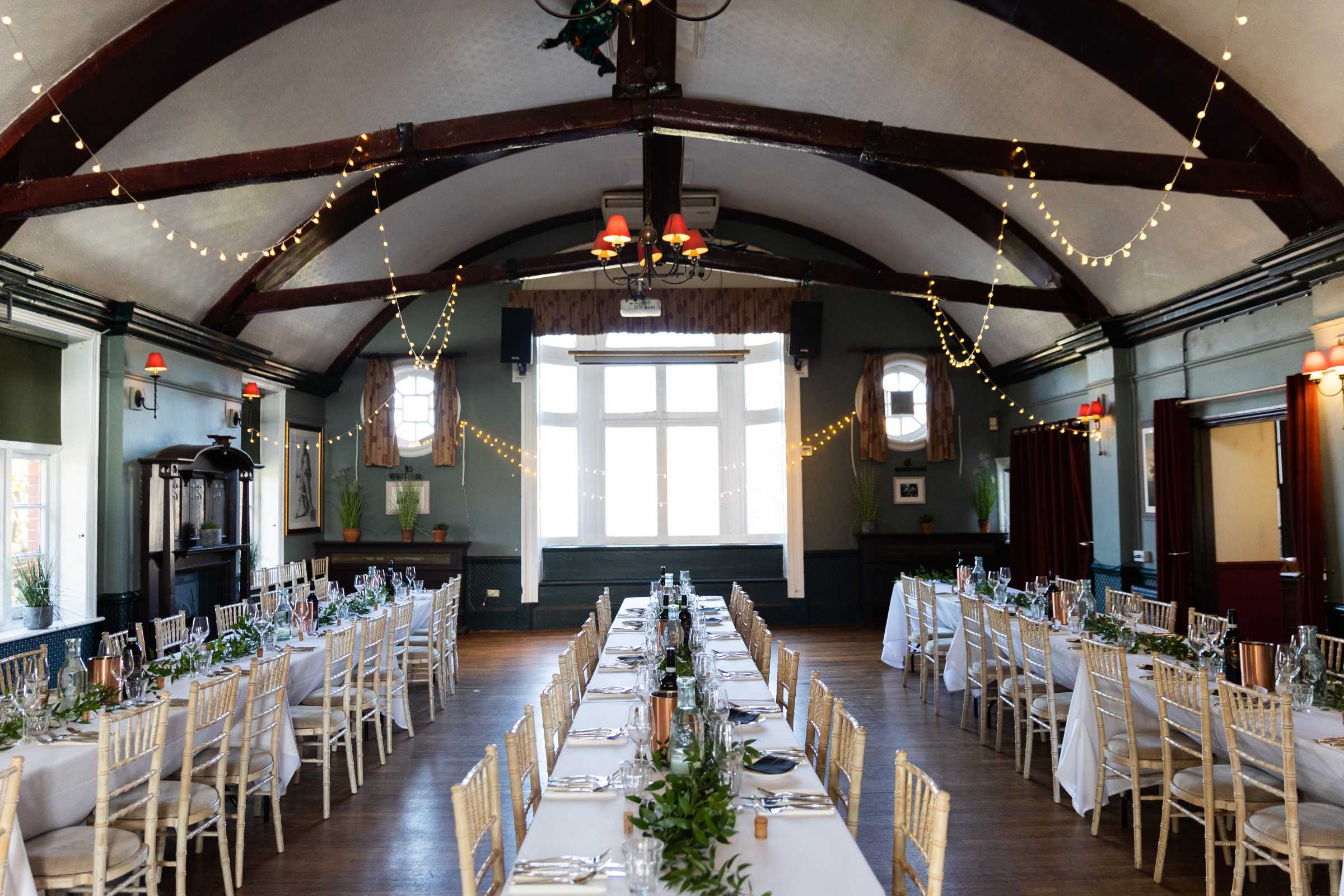 Spacious dining setup with round and long tables, ideal for weddings or parties with up to 180 guests.