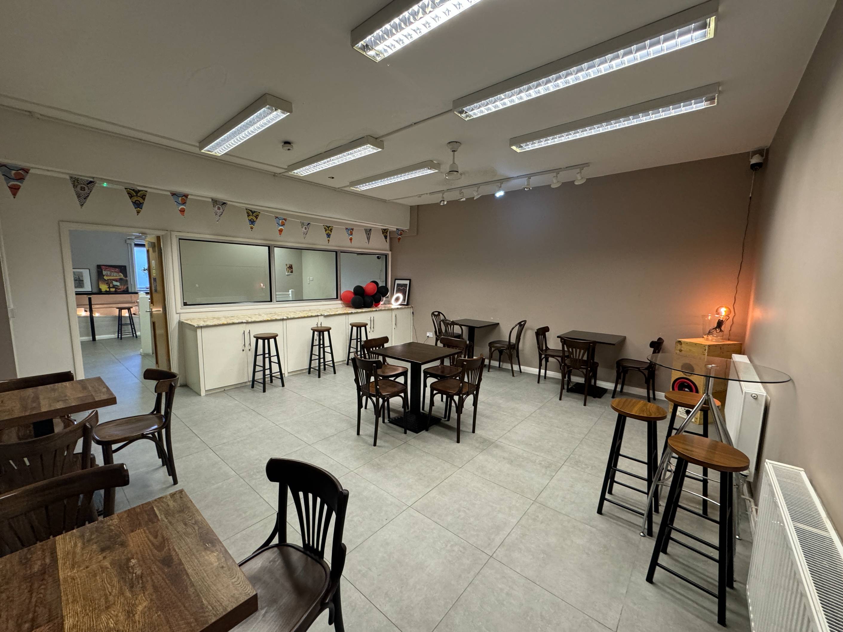 Bright upstairs interior of Brixtonia Lounge in Brixton, a flexible space for workshops and performances.