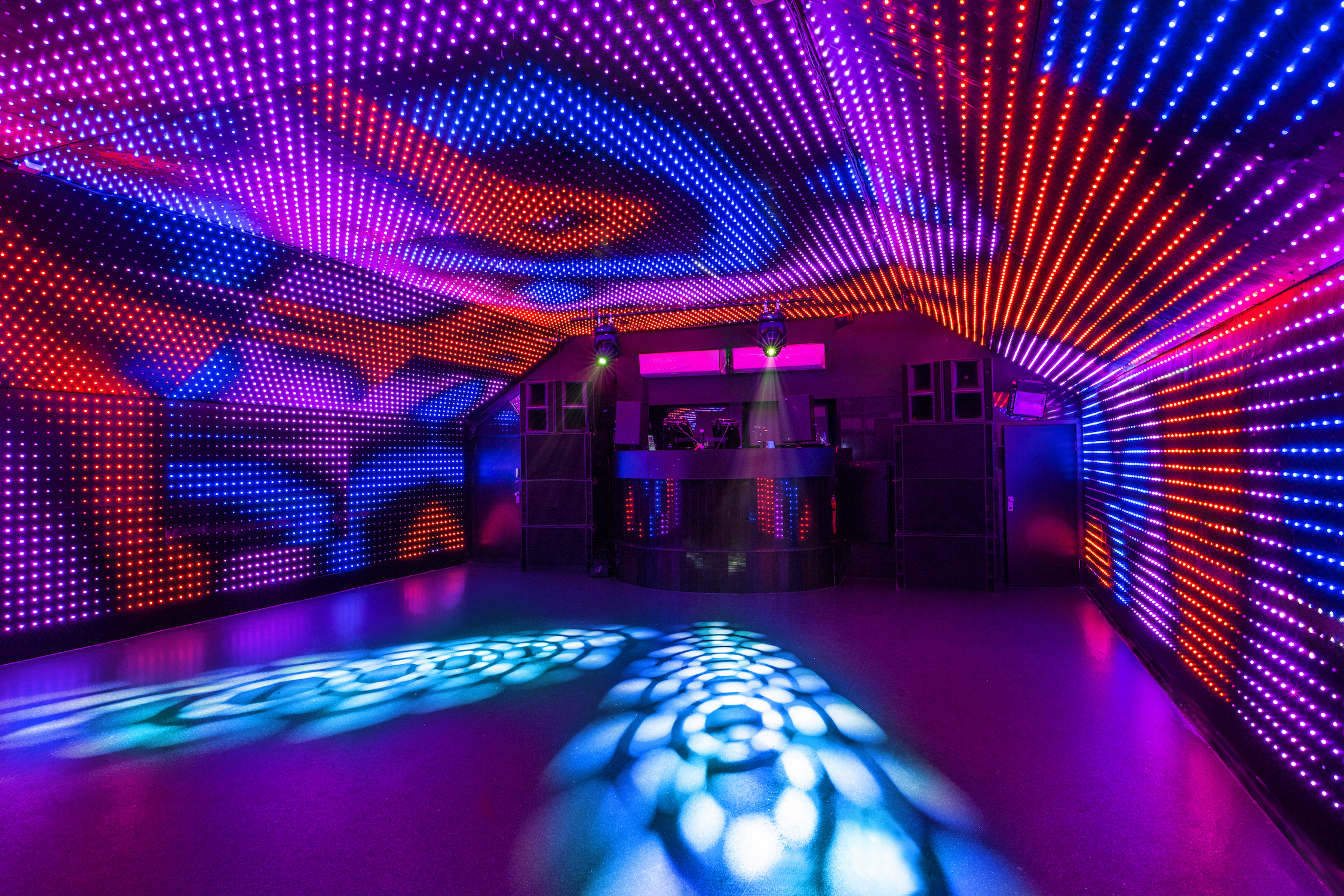 The Lightbox, 150-capacity venue, theatre-style seating with purple LED-lit walls and ceiling facing the stage, book via Conveenie.