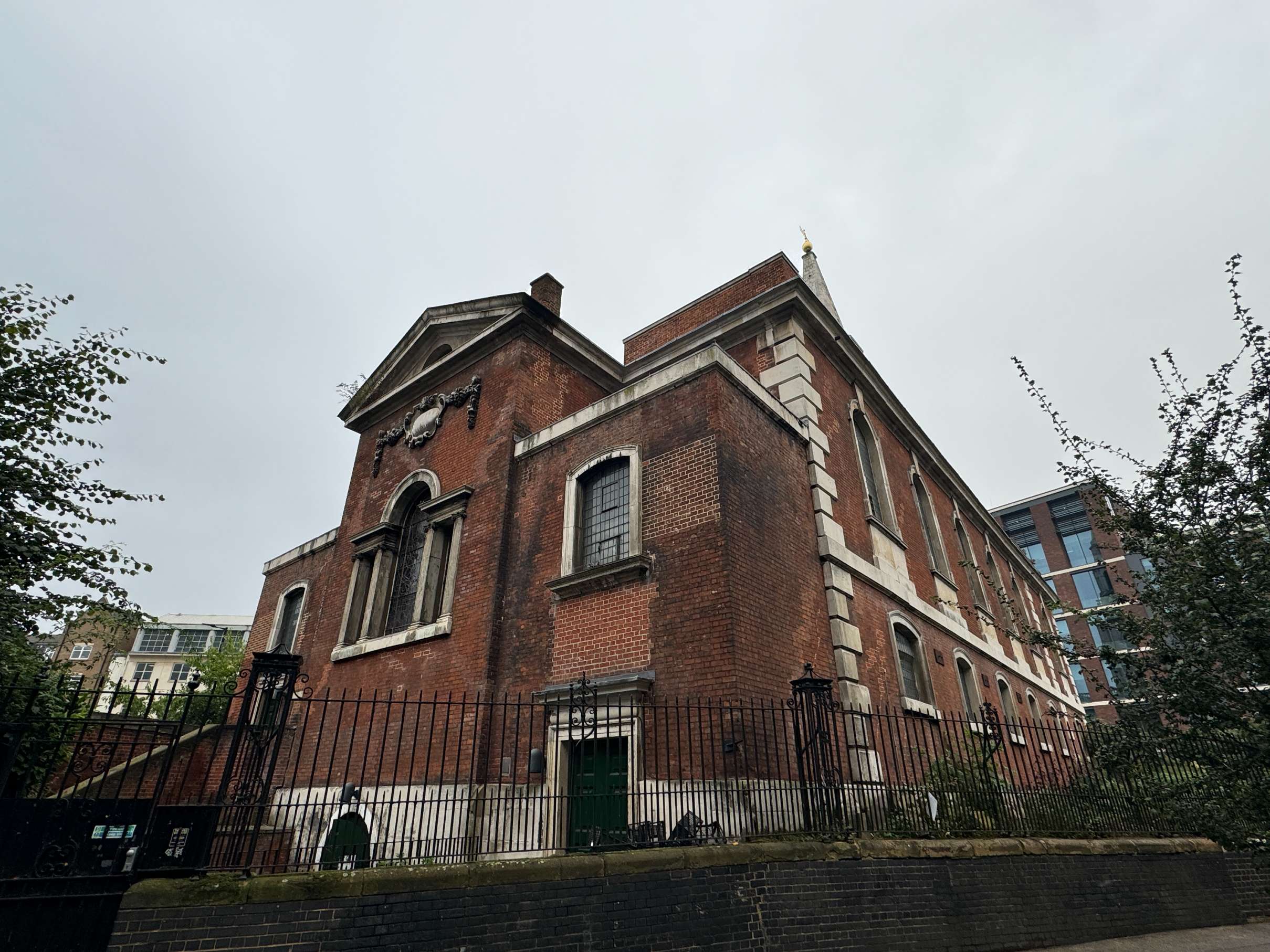 St George The Martyr’s side exterior view, with classic architecture near London Bridge—available via Conveenie