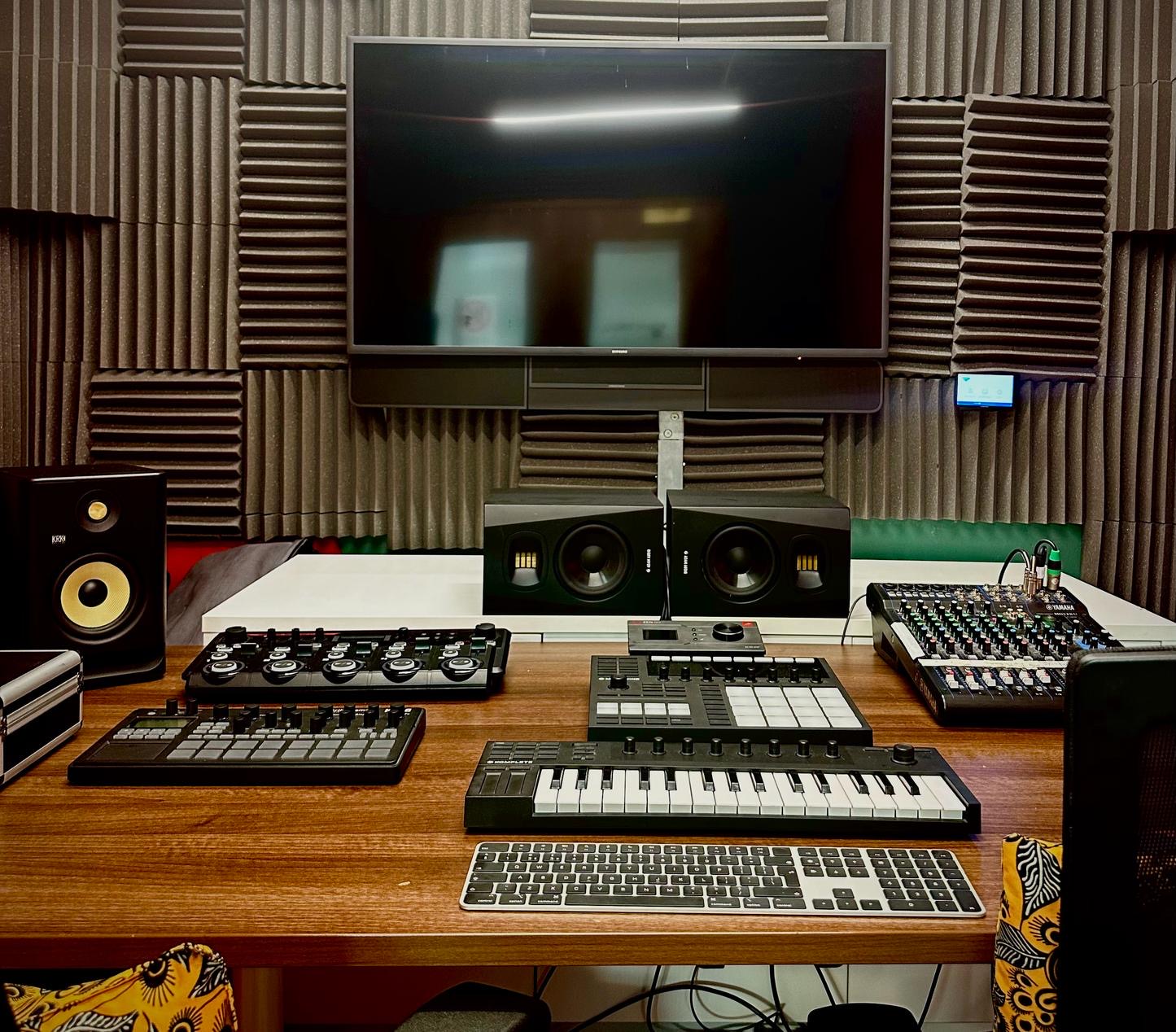 Recording Studio at Melanin Health & Wellness with wooden desk, keyboard, mixer, and speakers, bookable via Conveenie.